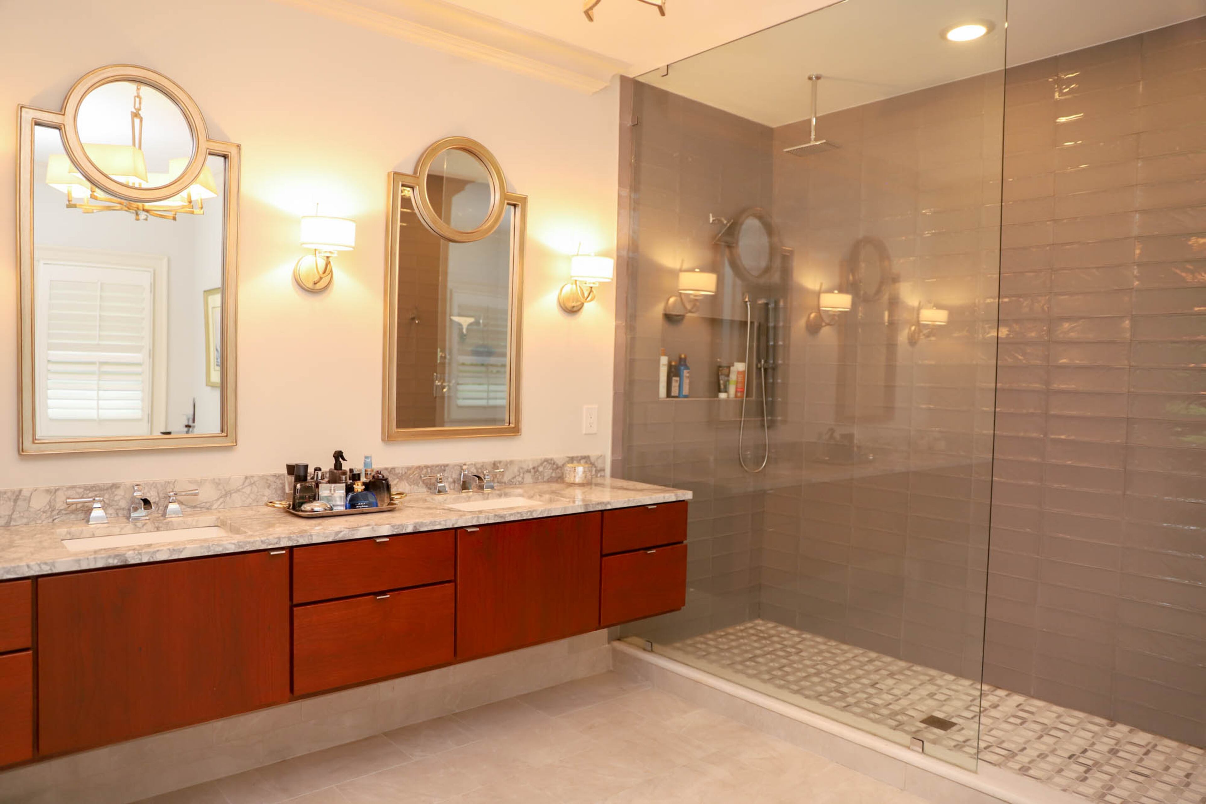 David Diehl and Jason Warshaw worked with builder Jessica Murphy of Her Cave Atlanta to completely renovate and refresh their master bathroom. "The hardware that she matched in the showers, tubs and on the sinks has a high end designer feel that we love, and the stone and tile have a rich look that reminds us of the luxury hotel rooms," said Warshaw. A floating bathroom vanity by CSI Kitchen & Bath Studio ties in with the rest of the home's warm hardwoods, while quartzite countertops installed by Atlantis Granite & Marble and shower tiles by Zumpano Enterprises and Floor & Decor give the space a clean, light look that the couple loves.