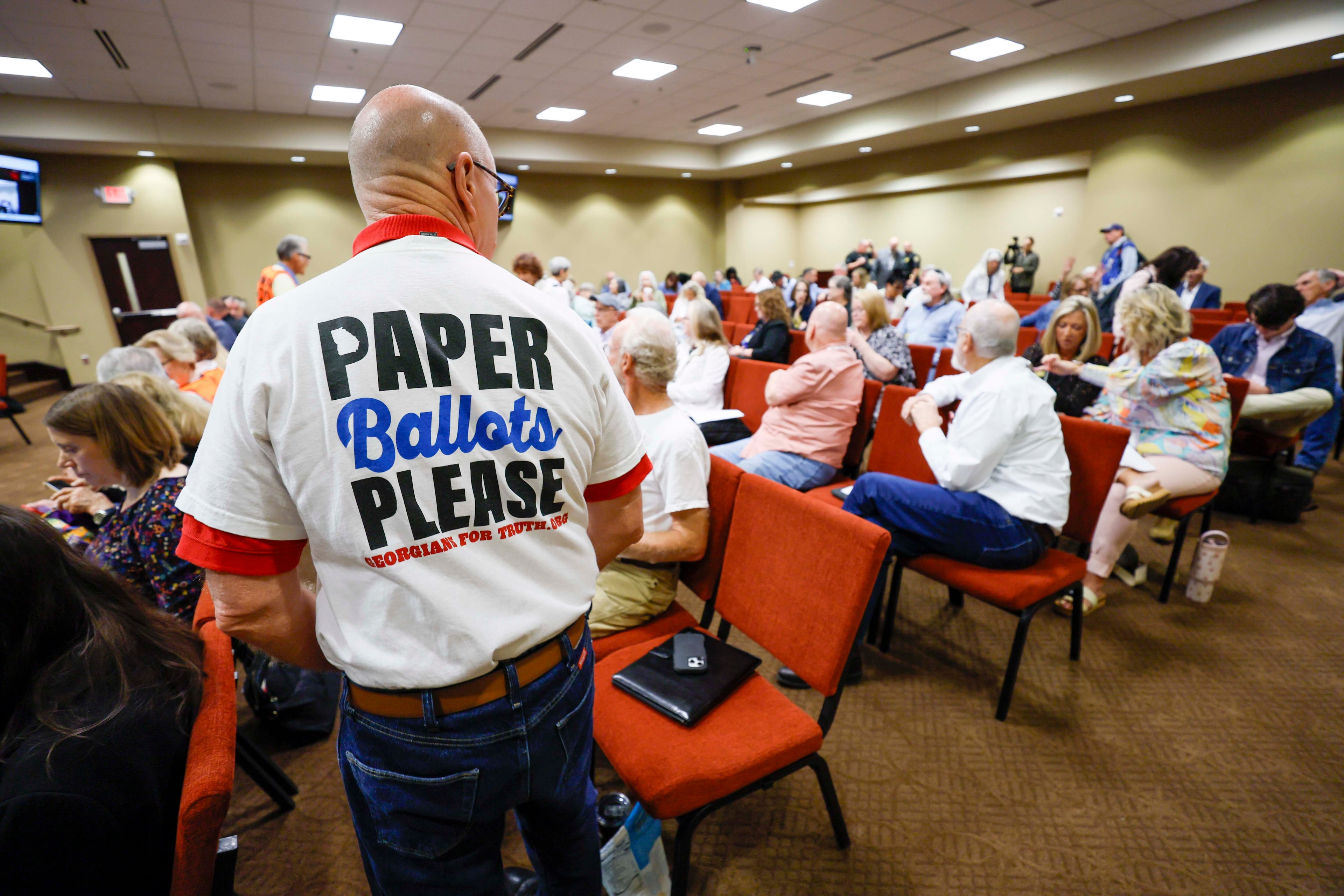 A paper ballot supporter attends a State Election Board meeting at Dawson County Government Center on Wednesday, April 25, 2026. (Miguel Martinez/AJC)