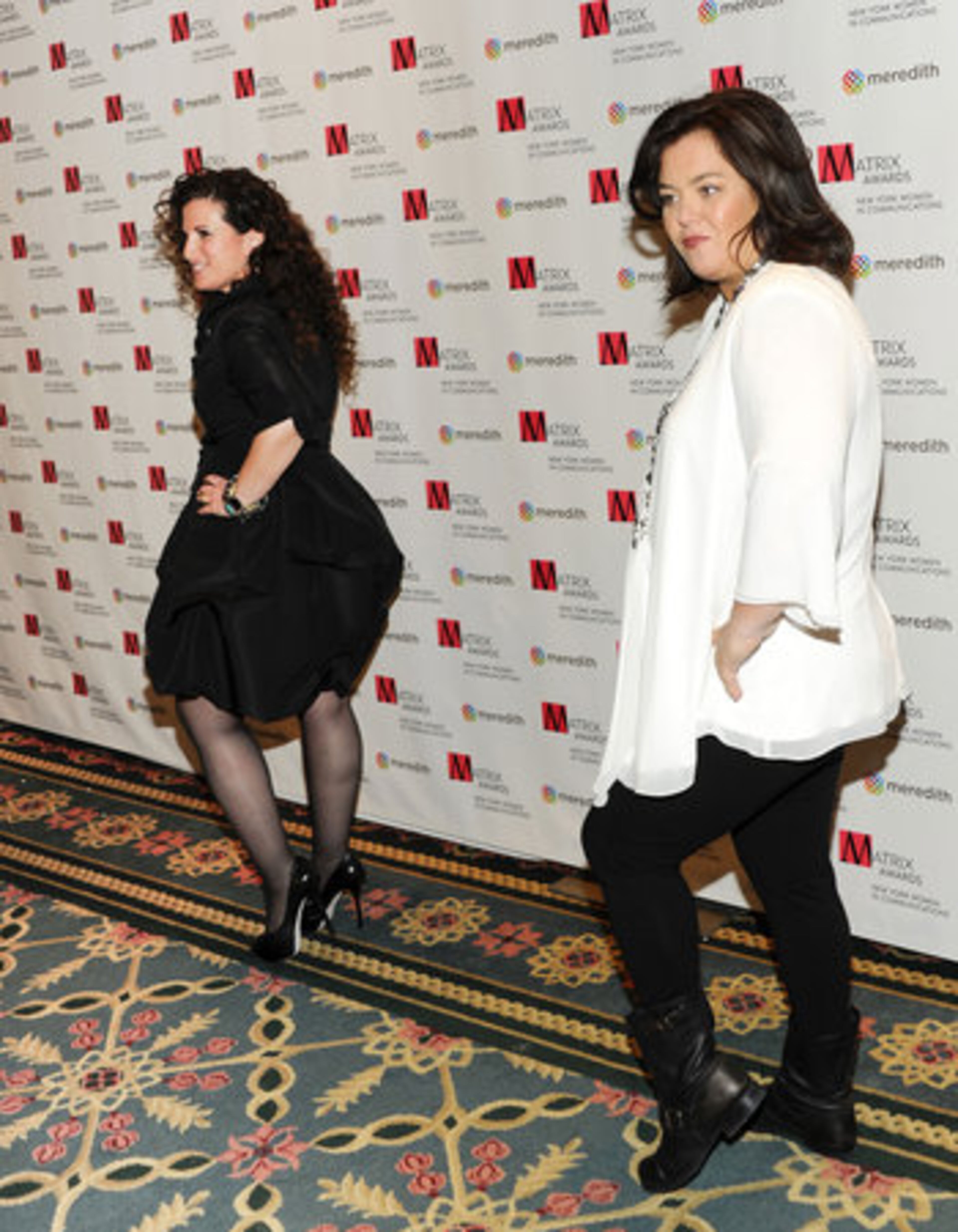 ROSIE ATTEMPTS TO BECOME AN HONORARY ROCKETTE: Honoree Cindi Berger, Chairman and CEO PMK-BNC Public Relations, left, and presenter Rosie O'Donnell strike a pose at the New York Women in Communications' 2011 Matrix Awards at the Waldorf-Astoria Hotel on Monday, April 11, 2011 in New York.