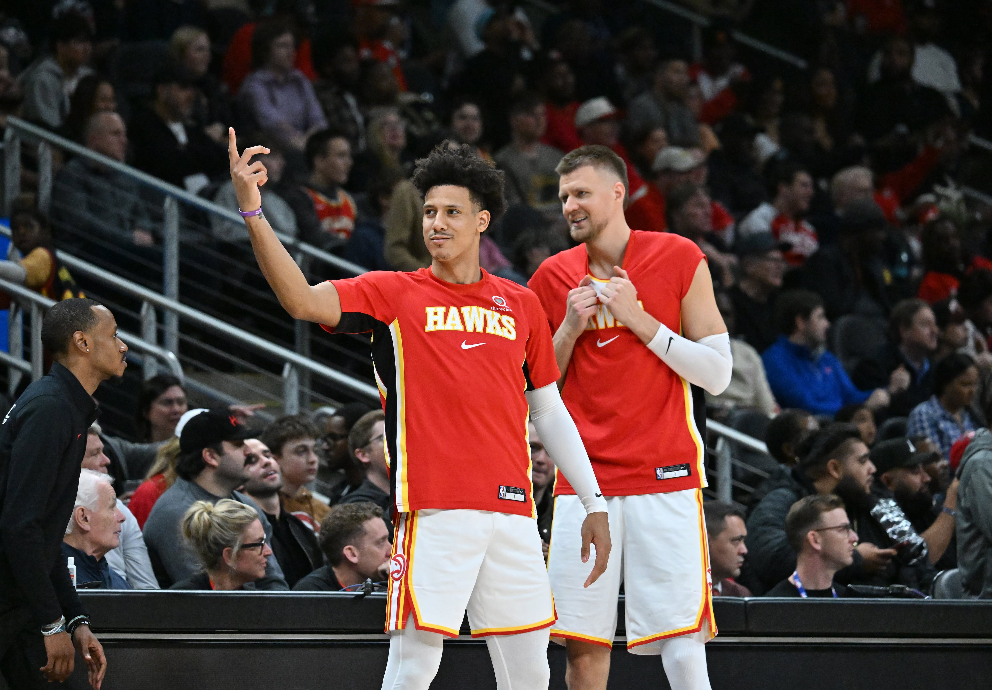 Atlanta Hawks forward Jalen Johnson (left) and Atlanta Hawks forward/center Kristaps Porziņģis react during the first half in an NBA basketball game at State Farm Arena, Wednesday, Jan. 7, 2026, in Atlanta. (Hyosub Shin/AJC)