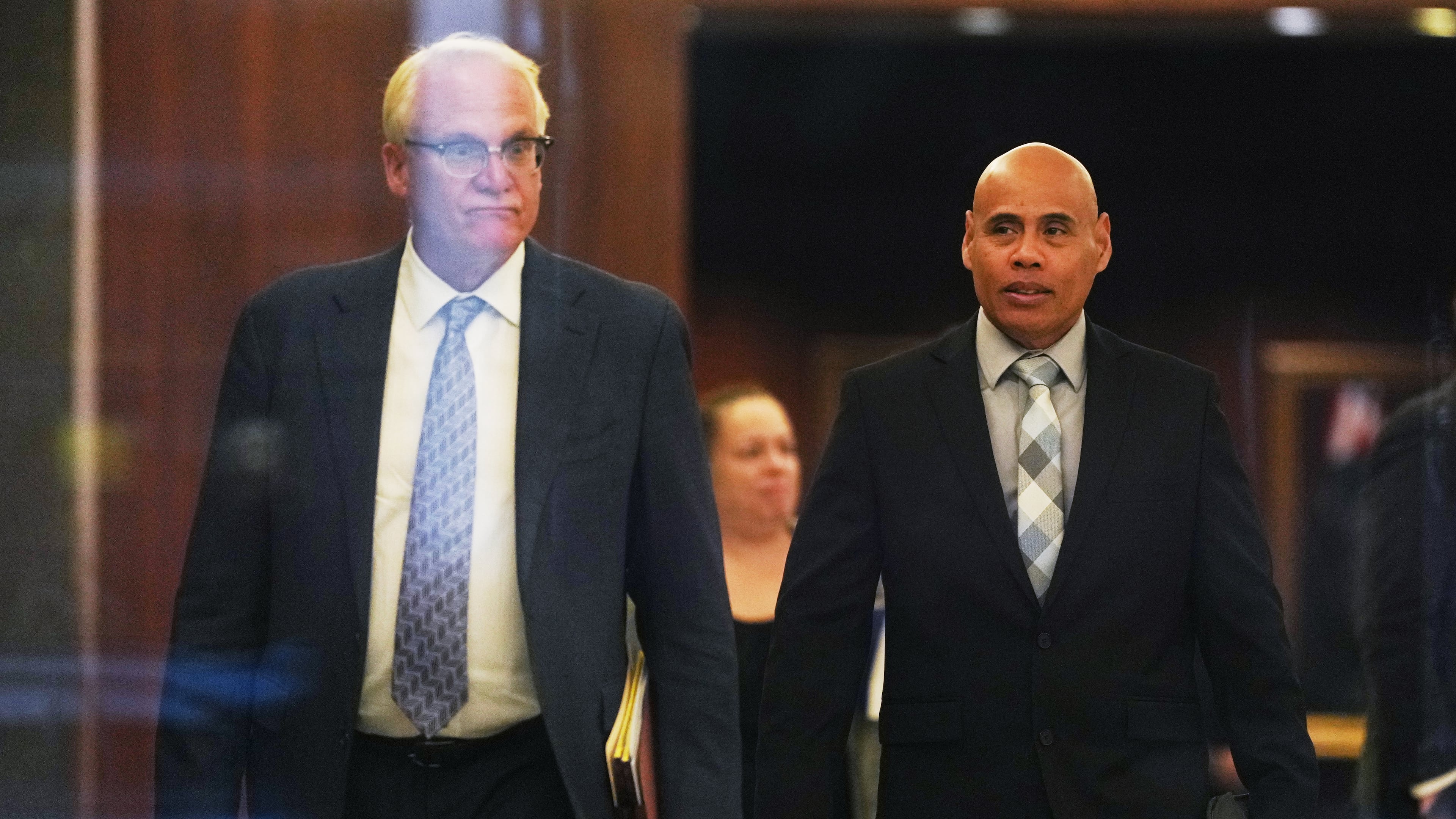 Christian Castro, right, an immigration officer who is accused of shooting a Venezuelan man during the immigration crackdown in Minneapolis early this year and lying to investigators about what happened, leaves with his attorney Daniel Gerdts, left, after a hearing at the Warren E. Burger Federal Building, Friday, Sept. 18, 2026, in St. Paul, Minn. (AP Photo/Ellen Schmidt)