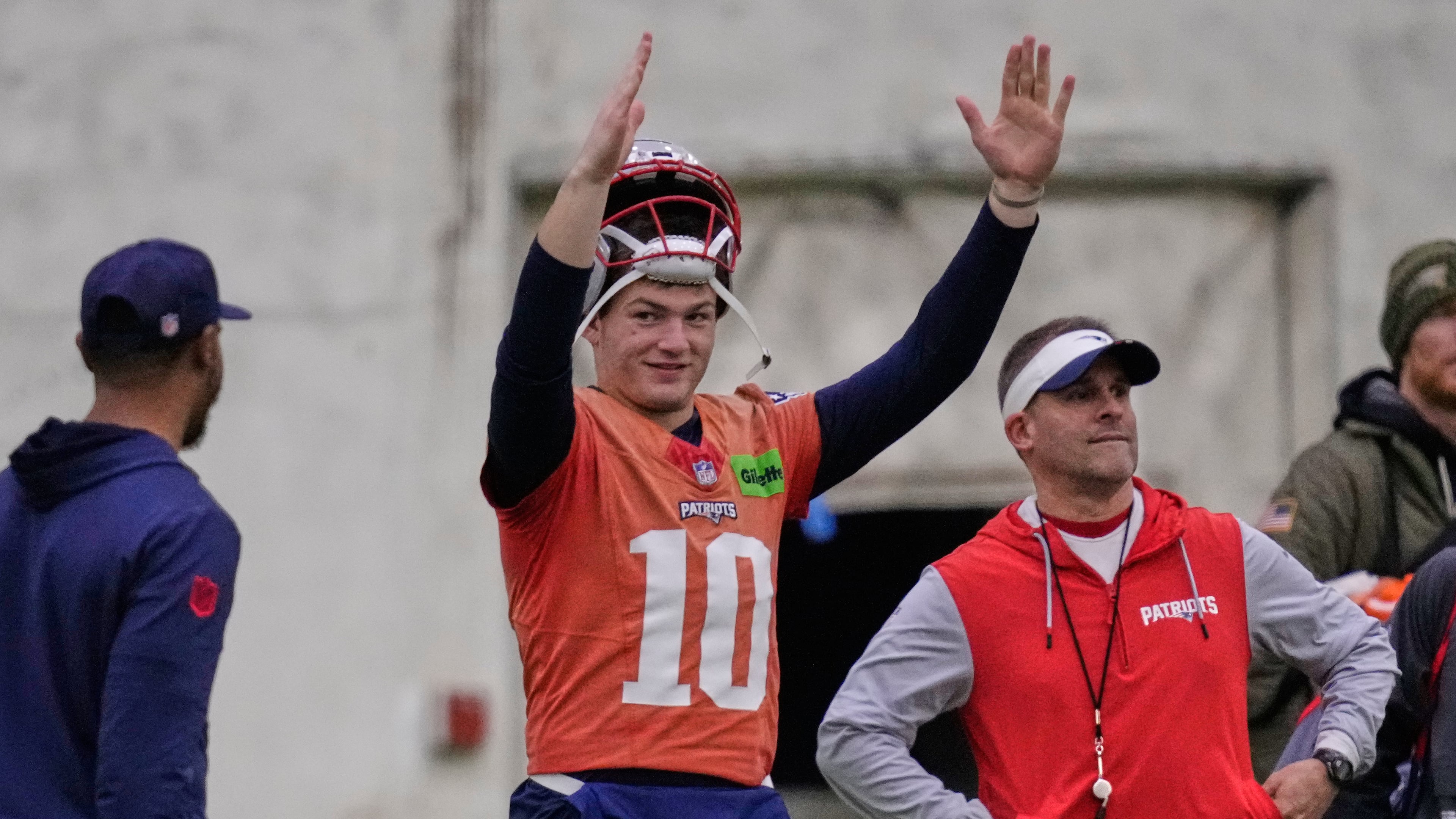 New England Patriots quarterback Drake Maye, left, signals after a field goal while standing with offensive coordinator Josh McDaniels during an NFL football availability, Thursday, Jan. 29, 2026, in Foxborough, Mass. (AP Photo/Charles Krupa)