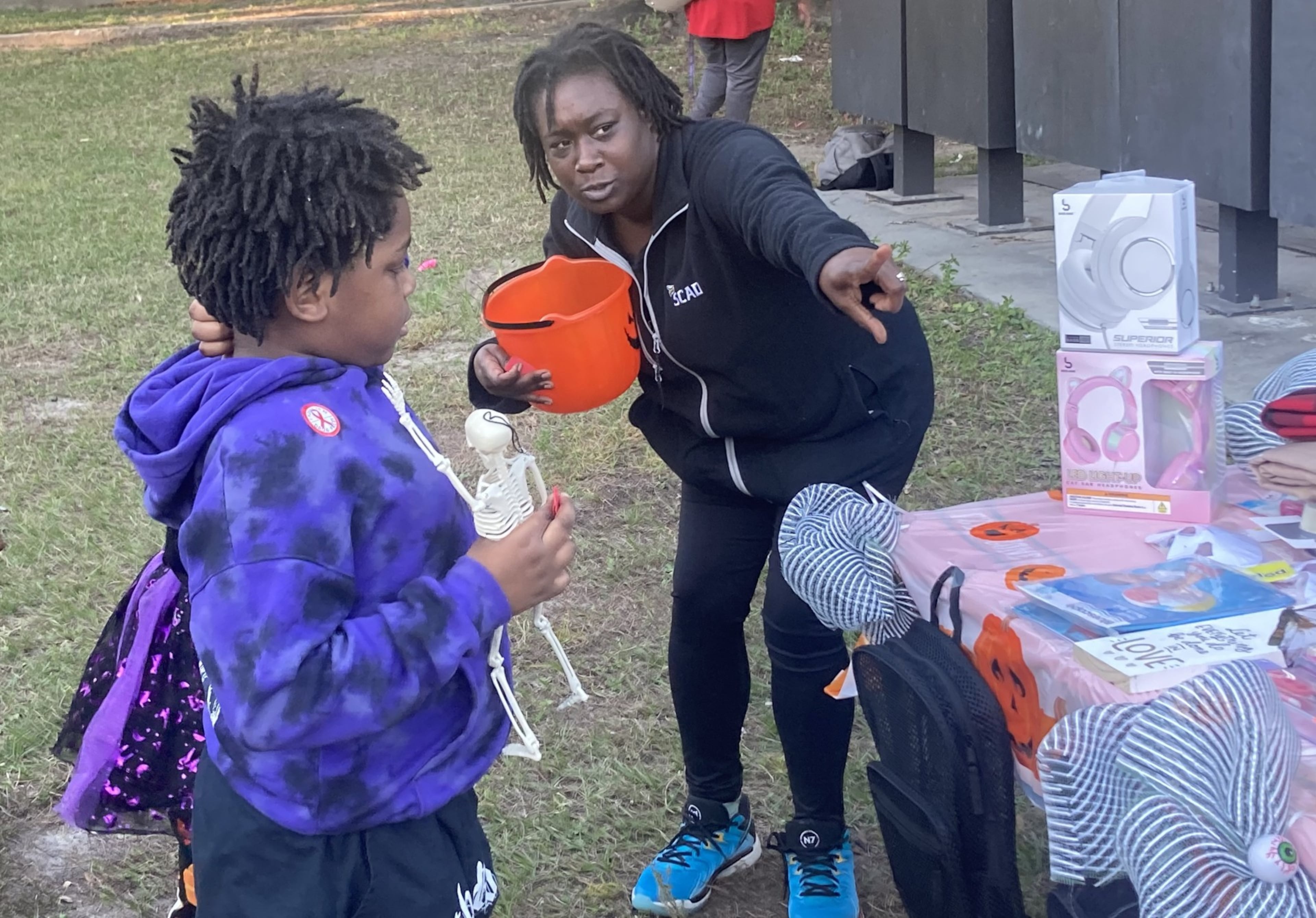Kevina Atkinson draws tickets in a toy raffle during the Yamacraw Village Halloween celebration on Friday, Oct. 31, 2025. (Adam Van Brimmer/AJC)