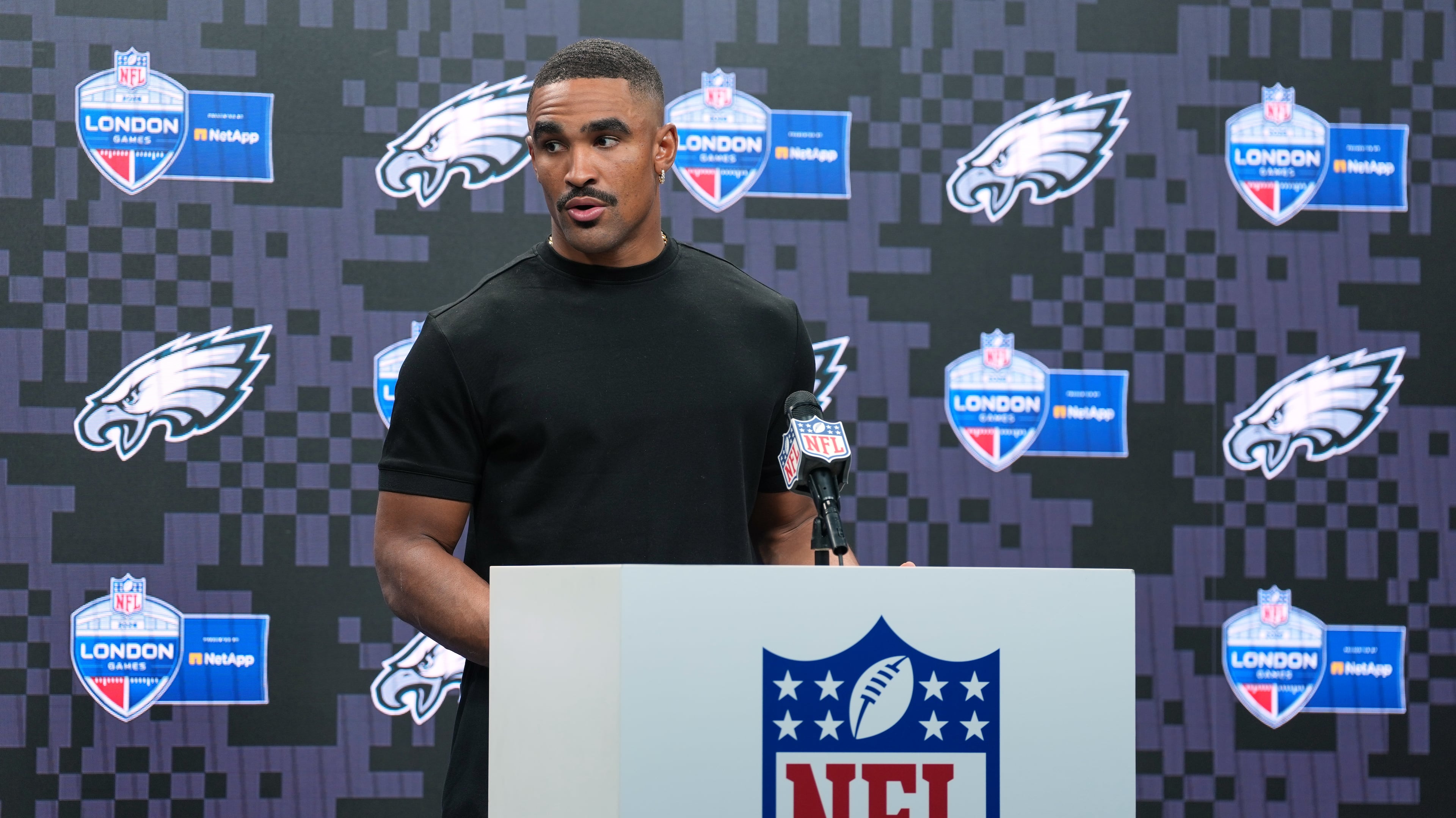 Philadelphia Eagles quarterback Jalen Hurts (1) attends a press conference after an NFL football game against Jacksonville Jaguars in London, Sunday, Oct. 11, 2026. (AP Photo/Alastair Grant)