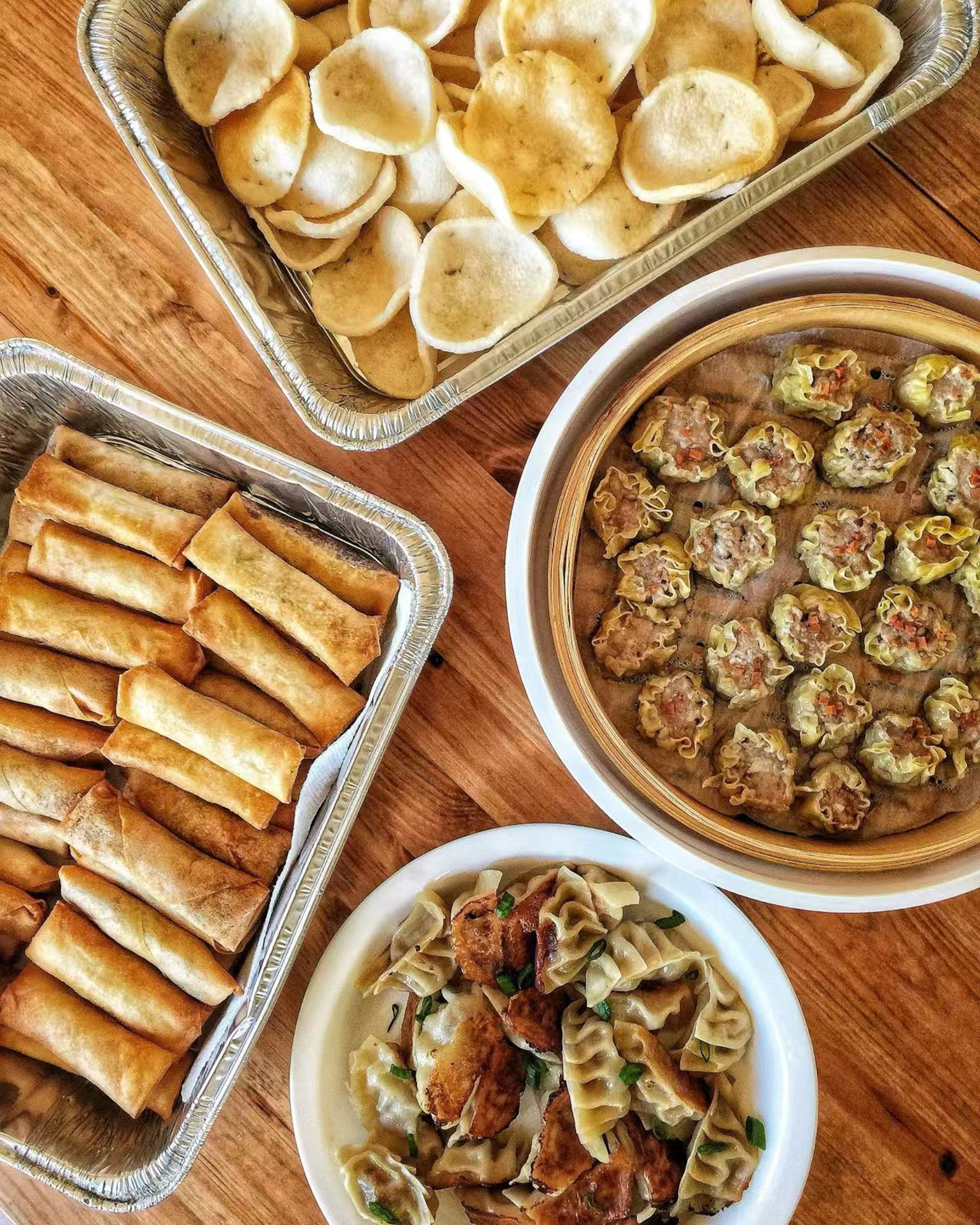 Soupbelly’s offerings include (clockwise from left): veggie spring rolls, shrimp chips, pork and shrimp siu mai and chicken and chive pot stickers. (Courtesy of Soupbelly)