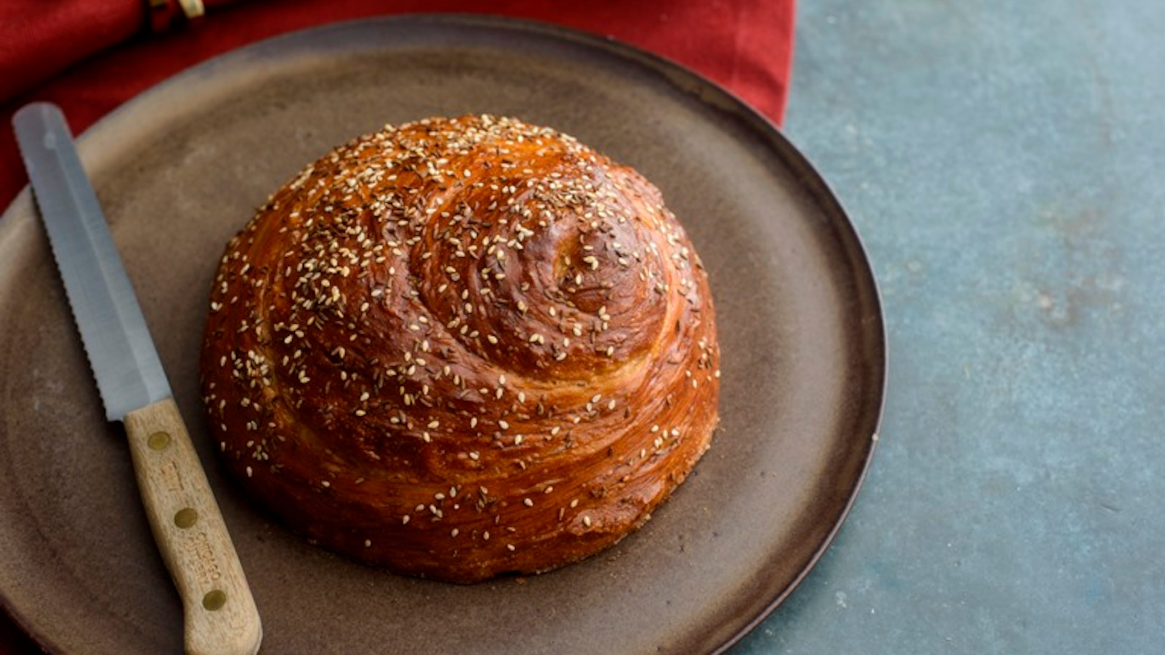 A loaf of Sephardic challah, in New York, Nov. 22, 2015. The braided, sweet challah familiar to Americans comes from Eastern European baking tradition; but in the Middle East and North Africa, where spicy cuisine reigns supreme and both eggs and sugar are scarce, Sabbath breads are made with olive oil and often make use of seeds and nuts.