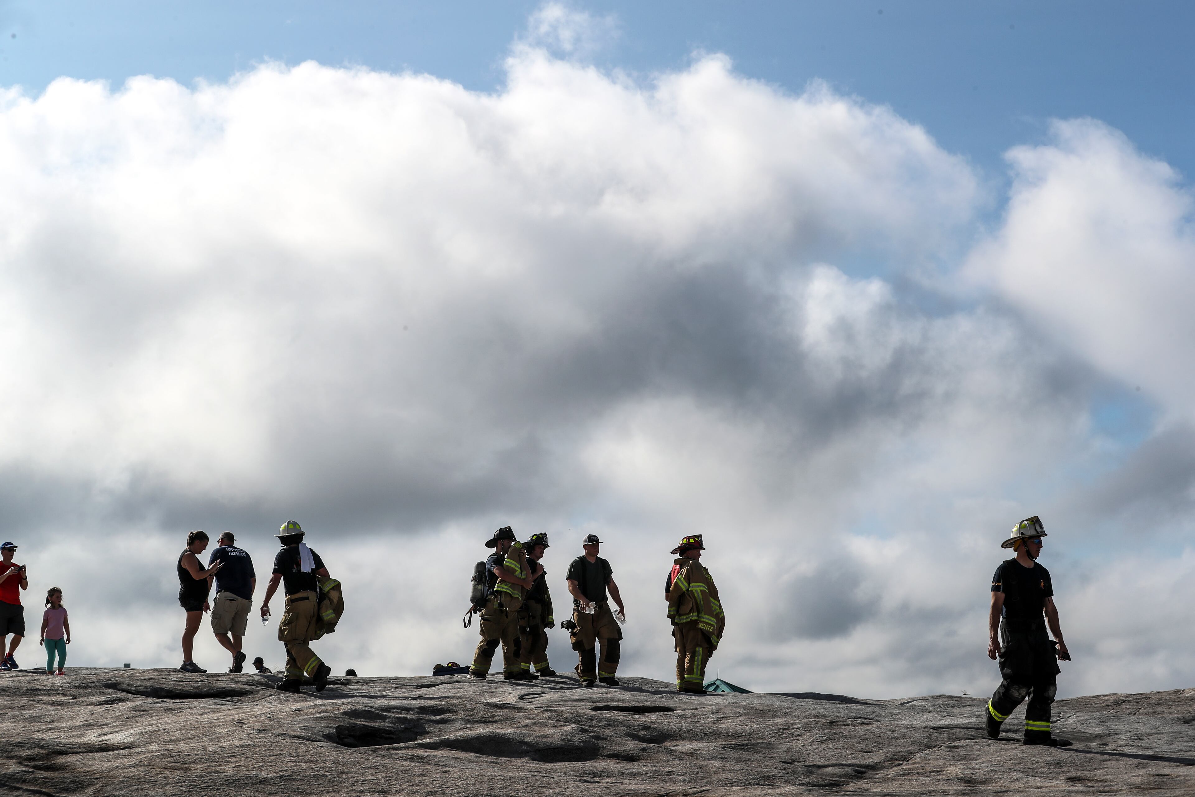 September 11, 2020 Stone Mountain: Over 100 firefighters from various metro Atlanta Fire departments including: Fayetteville Fire, Fayetteville Police, Fayette County Fire, Henry County Fire, Spalding County Fire, Union City Fire, Morrow Fire, Barrow County Fire, Johns Creek Fire, Gwinnett County Fire and DeKalb County Fire Rescue ascended Stone Mountain on Friday, Sept. 11, 2020 to commemorate the 19th anniversary of the Sept. 11 attacks on the United States. The 6th annual climb was sponsored by the Fayetteville Fire Department who challenged themselves and fellow firefighters to the one-mile climb, equivalent to 160 flights of stairs. Wearing a full complement of firefighting gear, the group tested their endurance in honor of the sacrifices made by 343 firefighters and paramedics who lost their lives on Sept. 11, 2001. Henry County police joined the group. (John Spink / John.Spink@ajc.com)