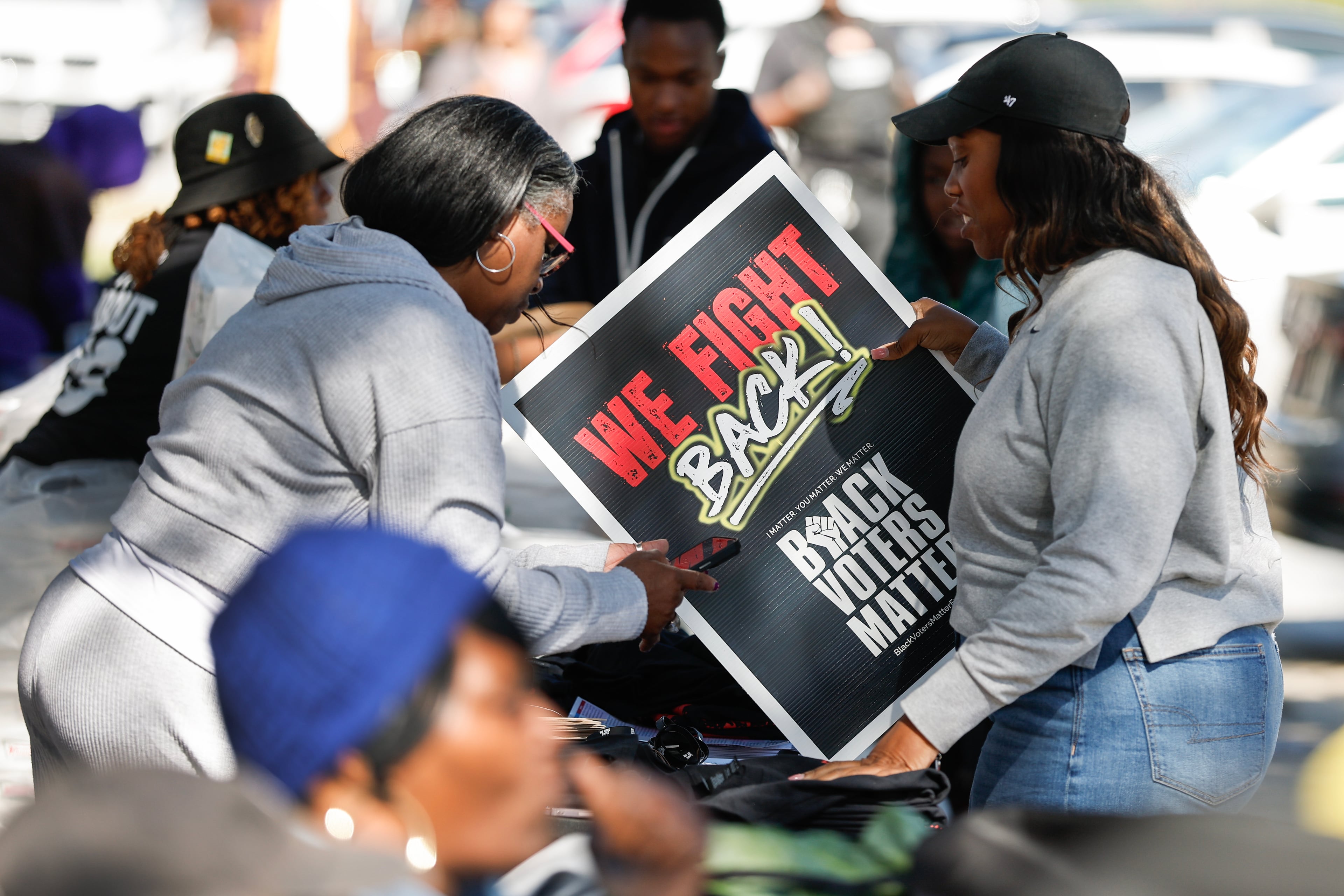 A person receives election materials during the Black Voters Matter “No Kings: Vote Early Atlanta” event at the C.T. Martin Natatorium and Recreation Center on Saturday, Oct. 17, 2026, in Atlanta. (Erik S. Lesser for the AJC)