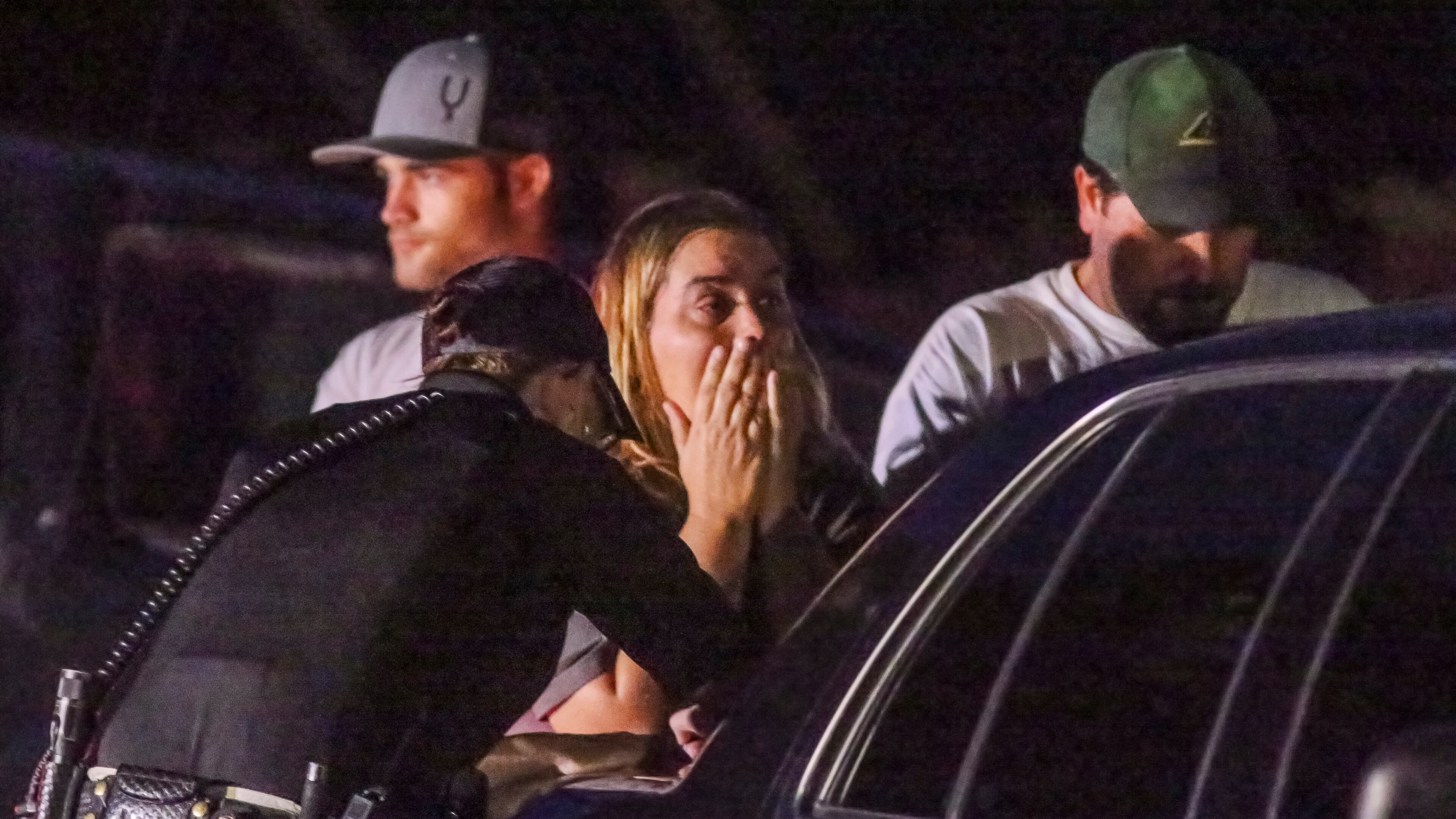 Distraught family and friends at the scene where three people were killed and one person critically injured in an October shooting.