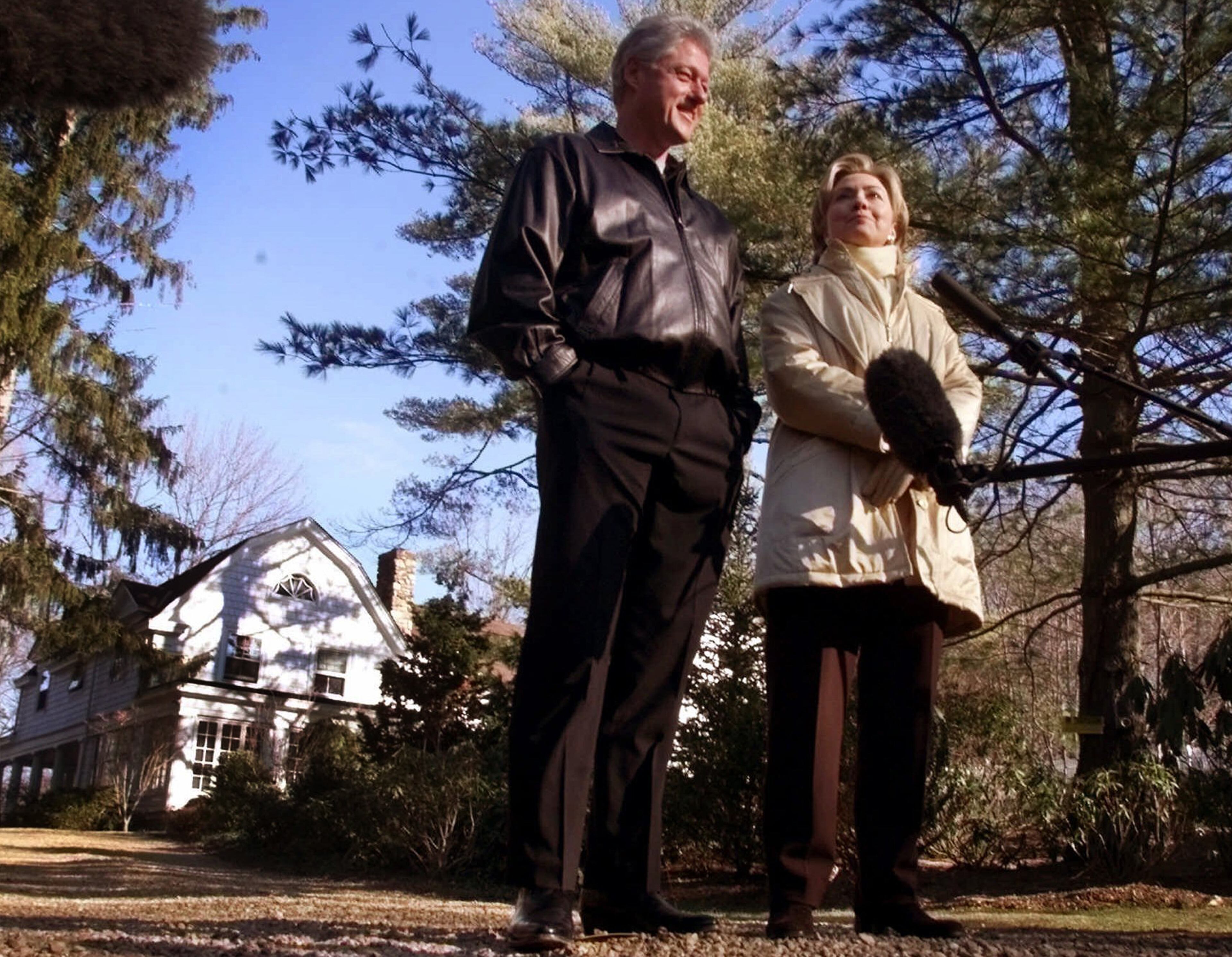 In this Jan. 6, 2000 file photo, Bill and Hillary Clinton stand in the driveway of their new home in Chappaqua, N.Y. (AP Photo, File)