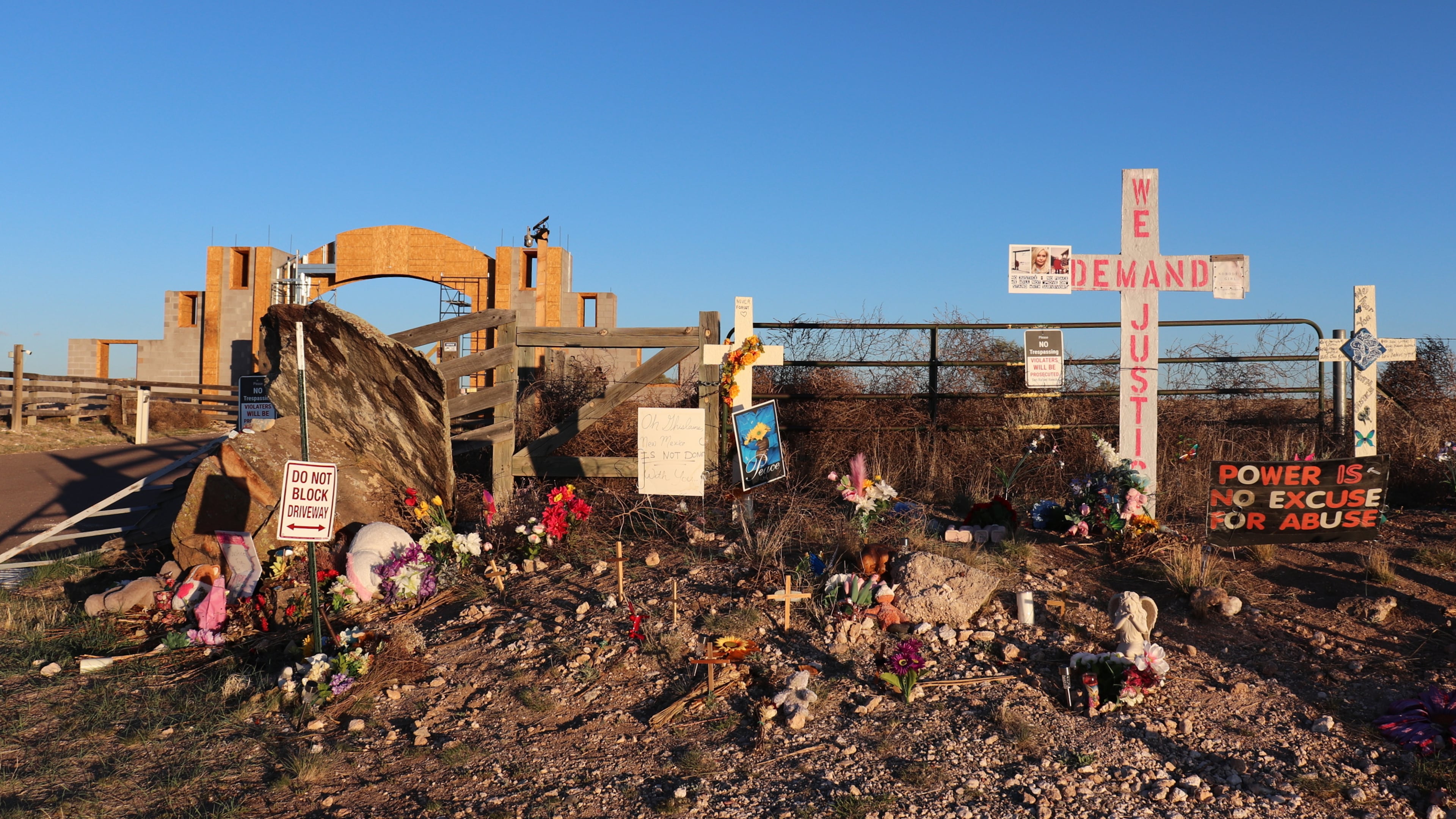 FILE - Crosses, flowers and other mementos are displayed outside Jeffrey Epstein's former Zorro Ranch near Stanley, N.M., on April 3, 2026. (AP Photo/Savannah Peters, File)