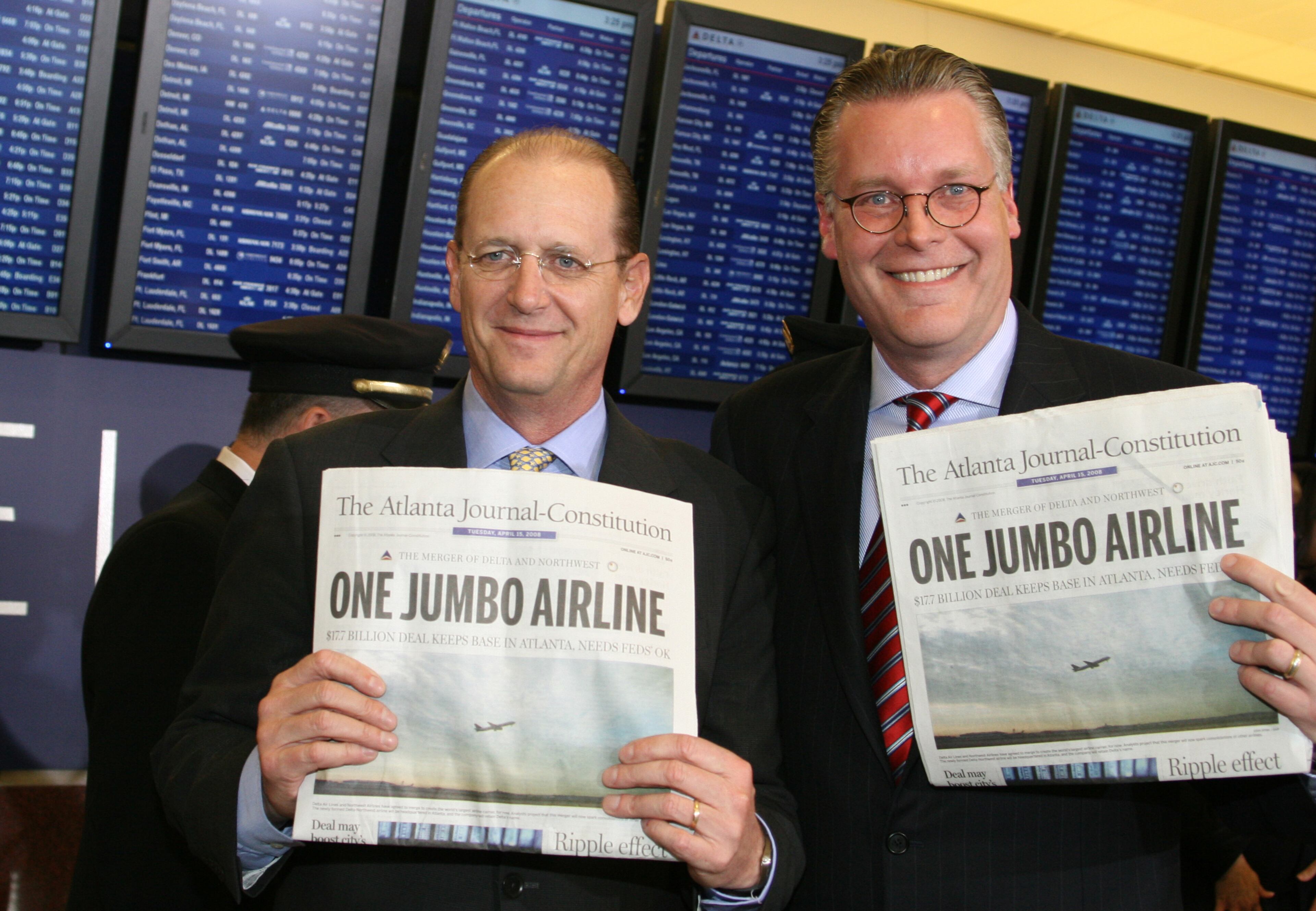 Delta CEO Richard Anderson (left) and CFO Ed Bastian (right) celebrate the merger of Delta Air Lines and Northwest Airlines, which consolidated operations in Atlanta on Oct. 29, 2008. Together the two temporarily became the world's largest airline. (Courtesy of Delta Air Lines)