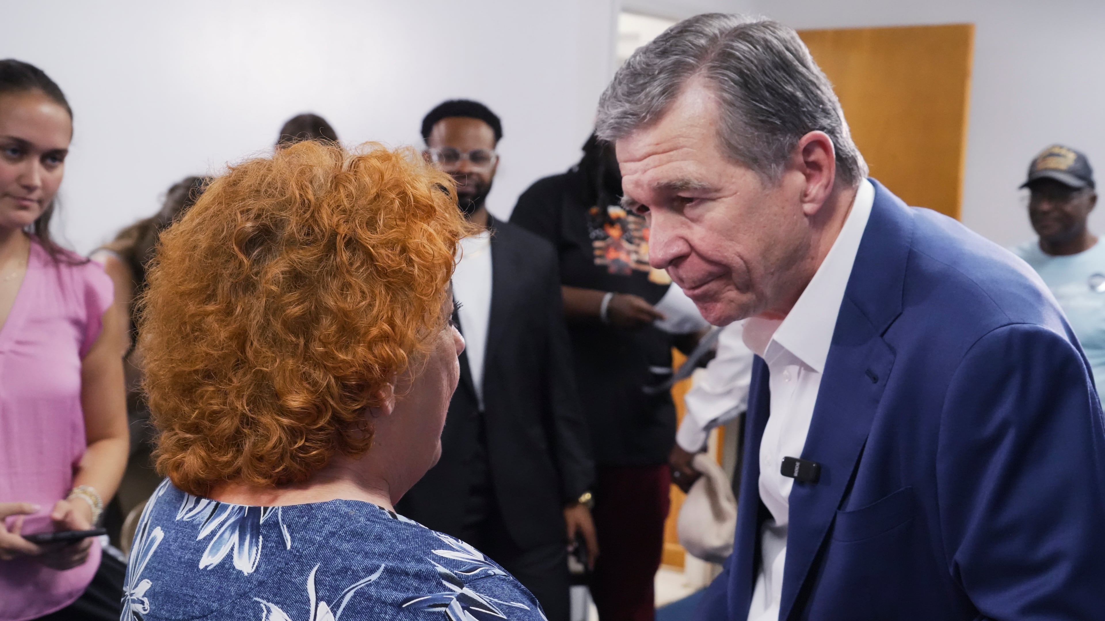 Former Democratic Gov. Roy Cooper, who is running for U.S. Senate, holds hands with a woman following a campaign event at St. James African Methodist Episcopal Church in Goldsboro, N.C., on Thursday, Sept. 10, 2026. (AP Photo/Allen G. Breed)