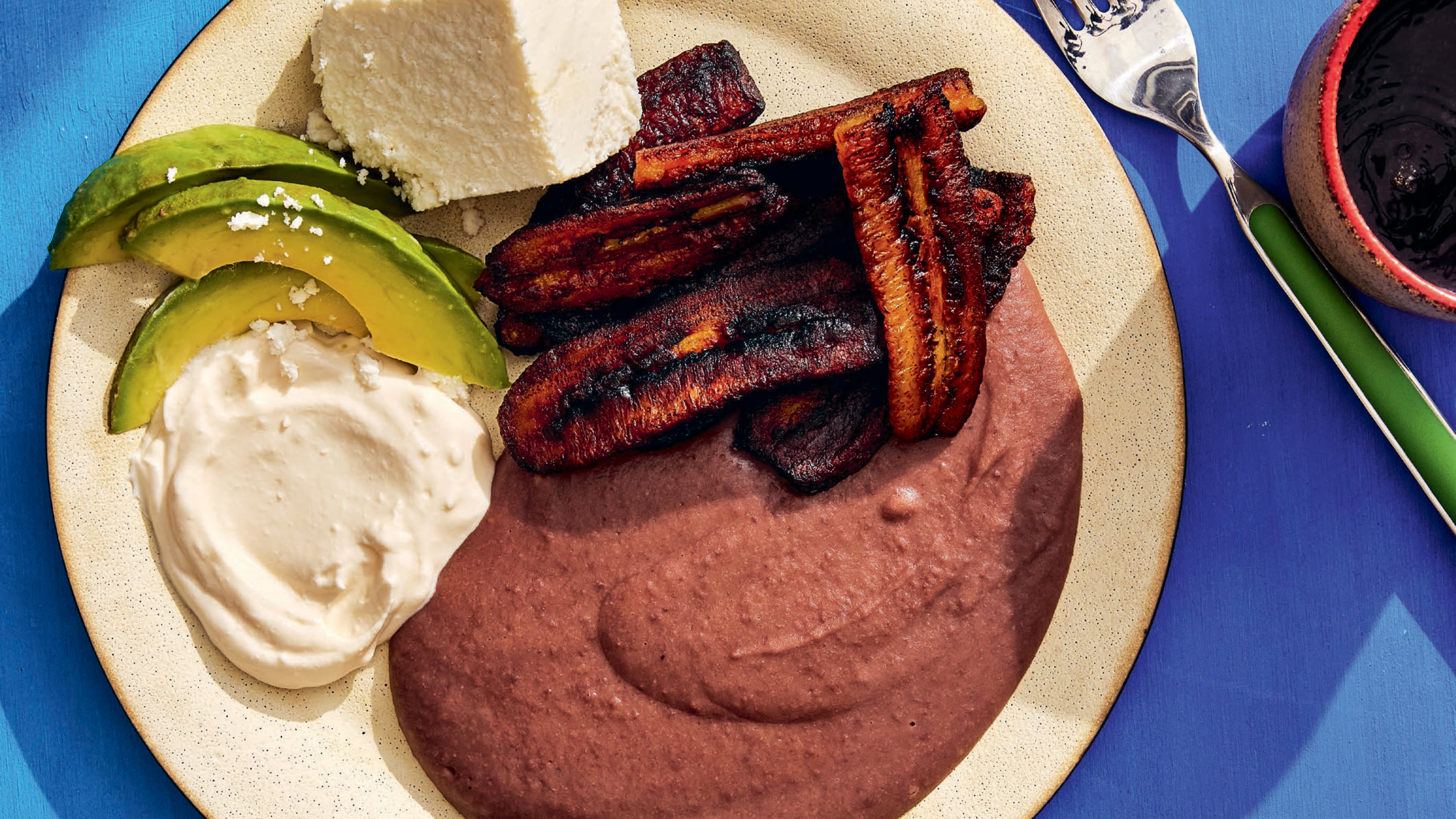 Platanos Fritos Con Frijoles Licuados (Fried Plantains with Pureed Black Beans) is a typical Salvadoran dish, found in "The SalviSoul Cookbook: Salvadoran Recipes and the Women who Preserve Them" by Karla Tatiana Vasquez. (Ren Fuller/Courtesy of Ten Speed Press(