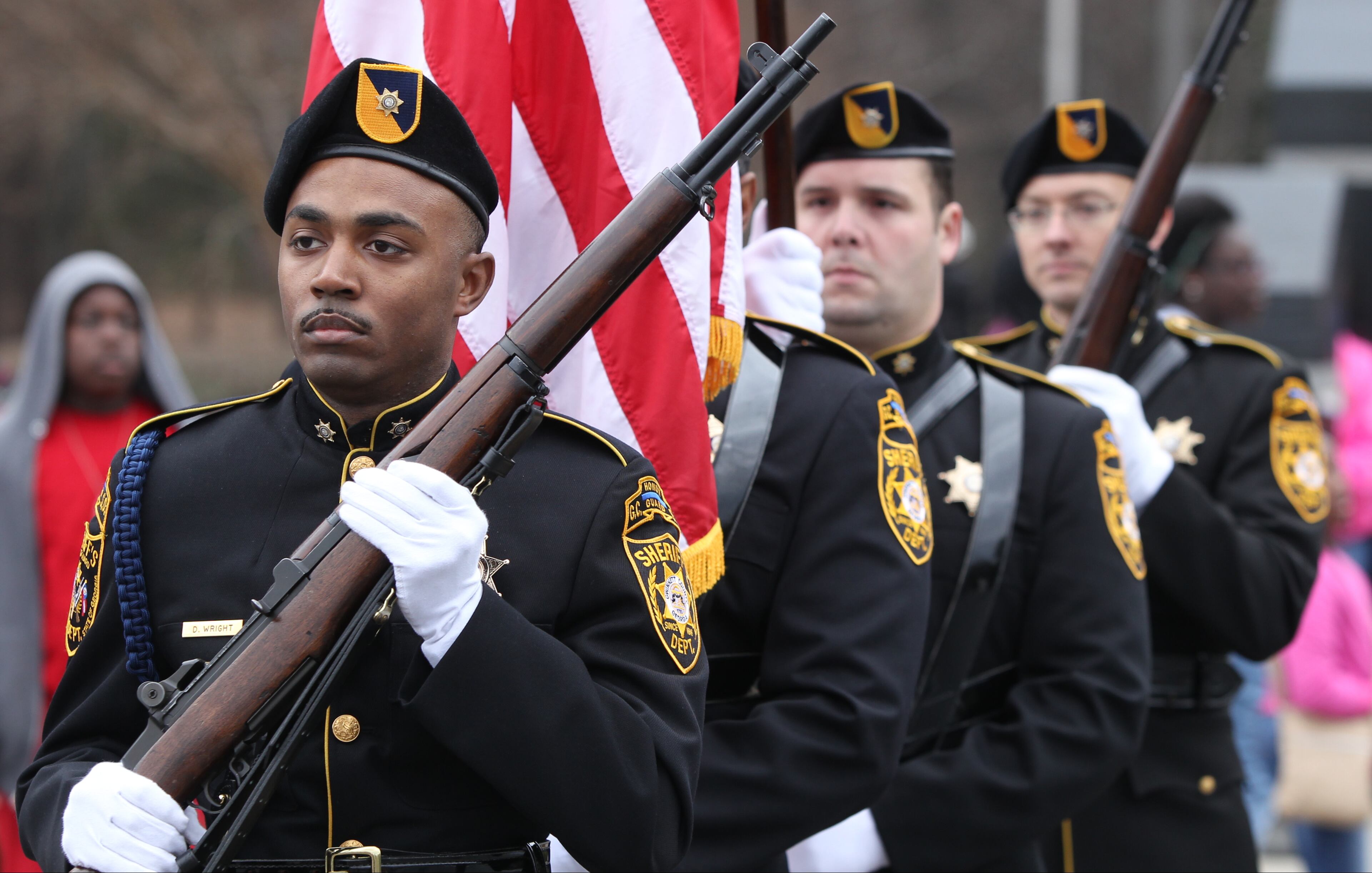 January 16, 2017, Atlanta - Members of the Gwinnett County Sheriff's office march with the American flag during the opening ceremony of the Martin Luther King Jr. Day parade inLawrenceville, Georgia, on Monday, January 16, 2017. (HENRY TAYLOR / HENRY.TAYLOR@AJC.COM)