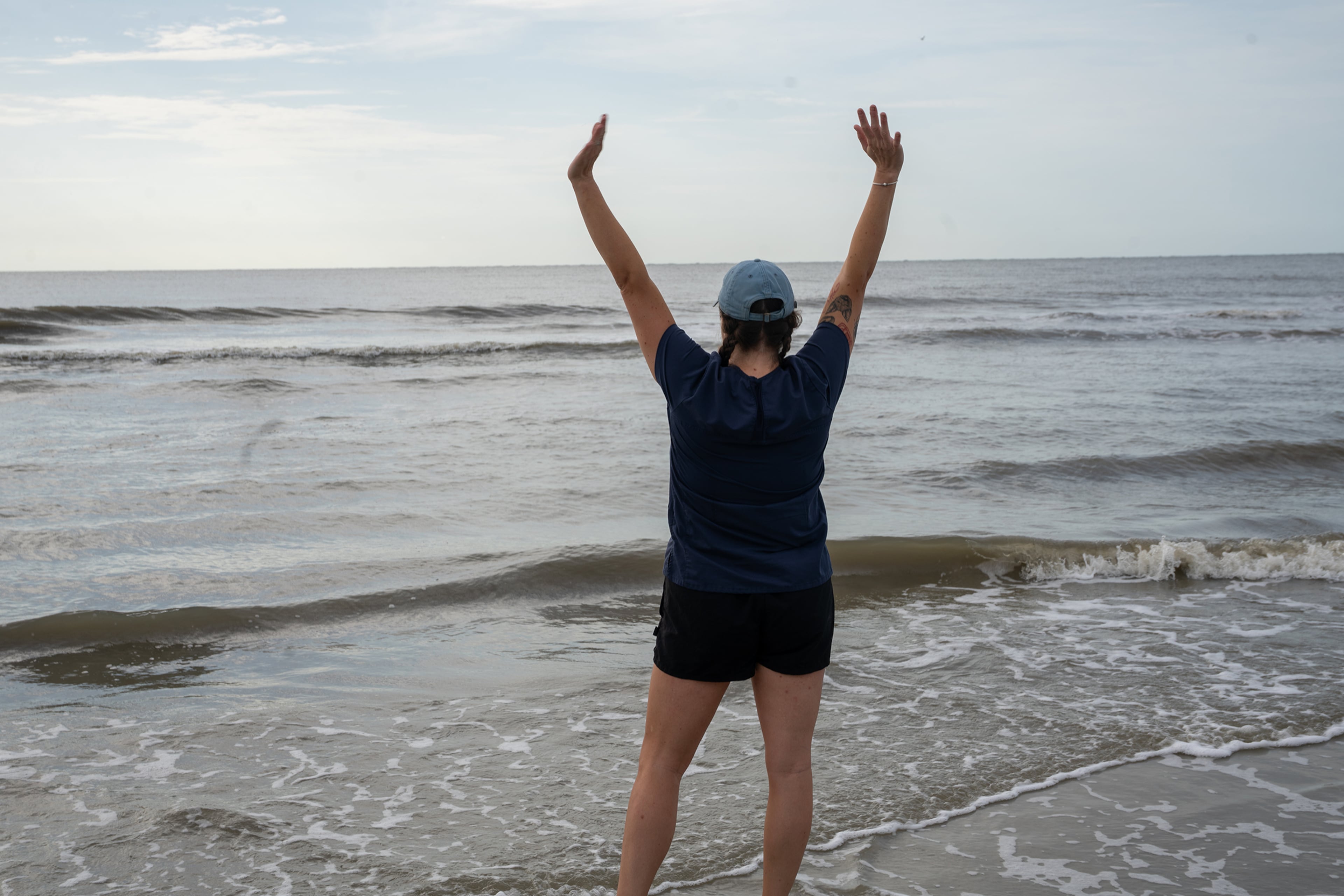 Lydia McDonald, a hospital technician at the Georgia Sea Turtle Center, signaled success after Earl Grey was returned to the Atlantic Ocean on Jekyll Island Thursday. (Courtesy of Georgia Sea Turtle Center)