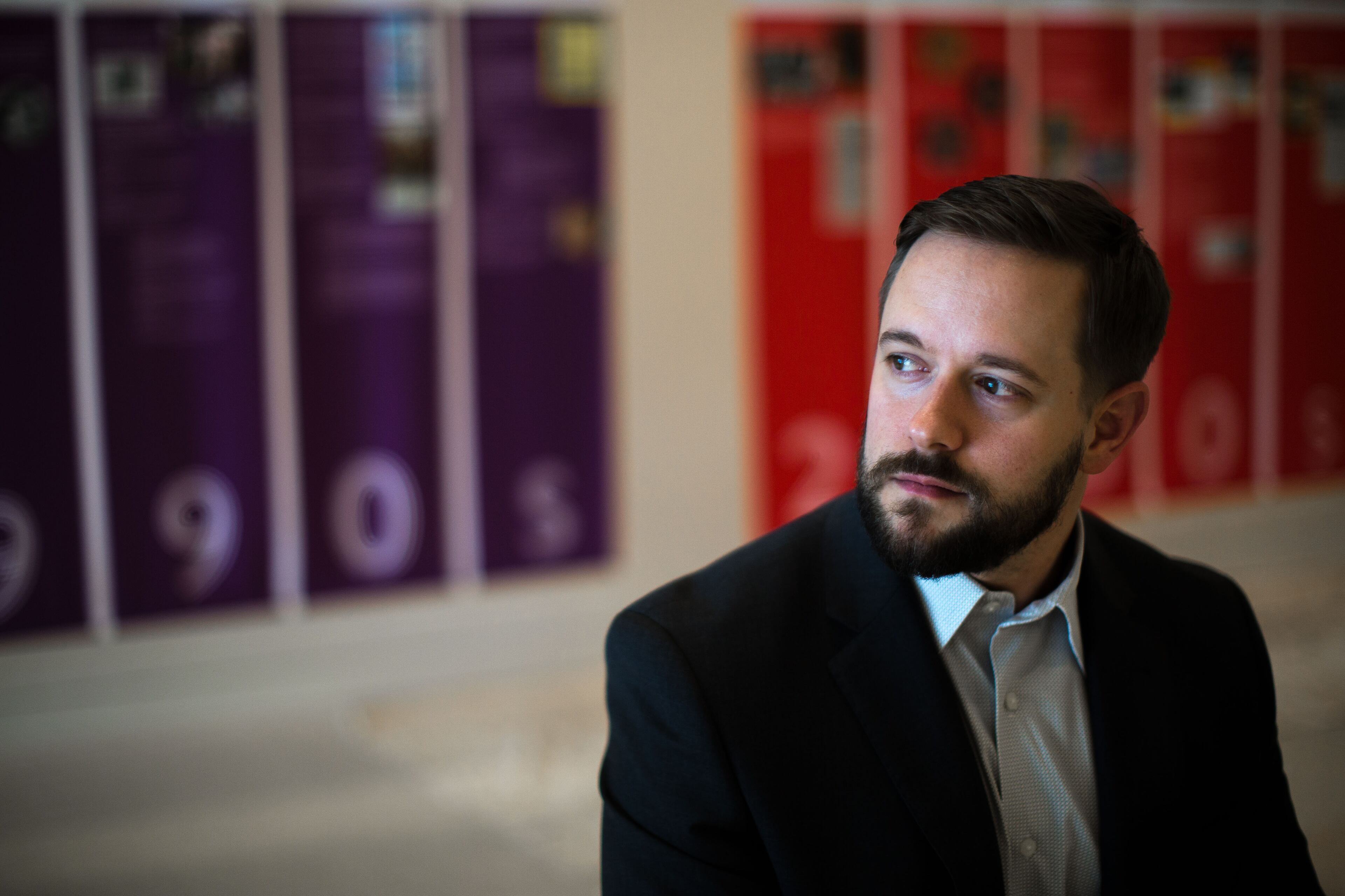 Ryan Roemerman, interim executive director for the LGBT Institute, poses for a portrait in front of the "Forward Together: A Look at Atlanta's LGBT History Since Stonewall" exhibit at the Center for Civil and Human Rights, Tuesday, Sept. 1, 2015, in Atlanta. Leaders of an Atlanta museum want the space focused on modern and historic civil rights to contribute to a national push to ensure LGBT rights, particularly in southern states. (AP Photo/Branden Camp)