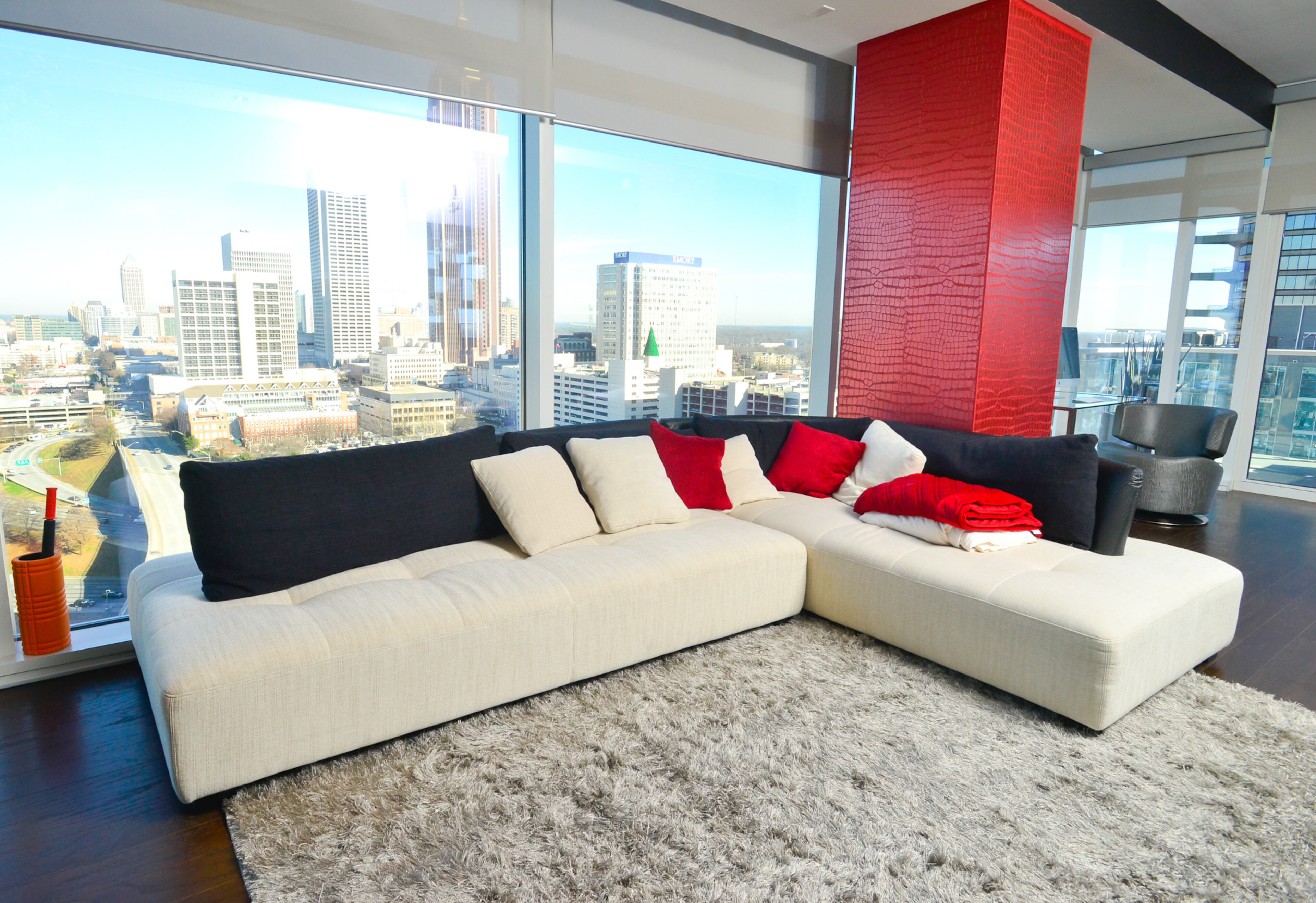 The downtown condo has floor-to-ceiling windows that give Atlanta Braves outfielder Jordan Schafer an unobstructed view of Midtown. He enjoys relaxing after games on a cream and black two-piece sectional sofa from By Design Furniture that includes a chaise. -- Text by Lori Johnston