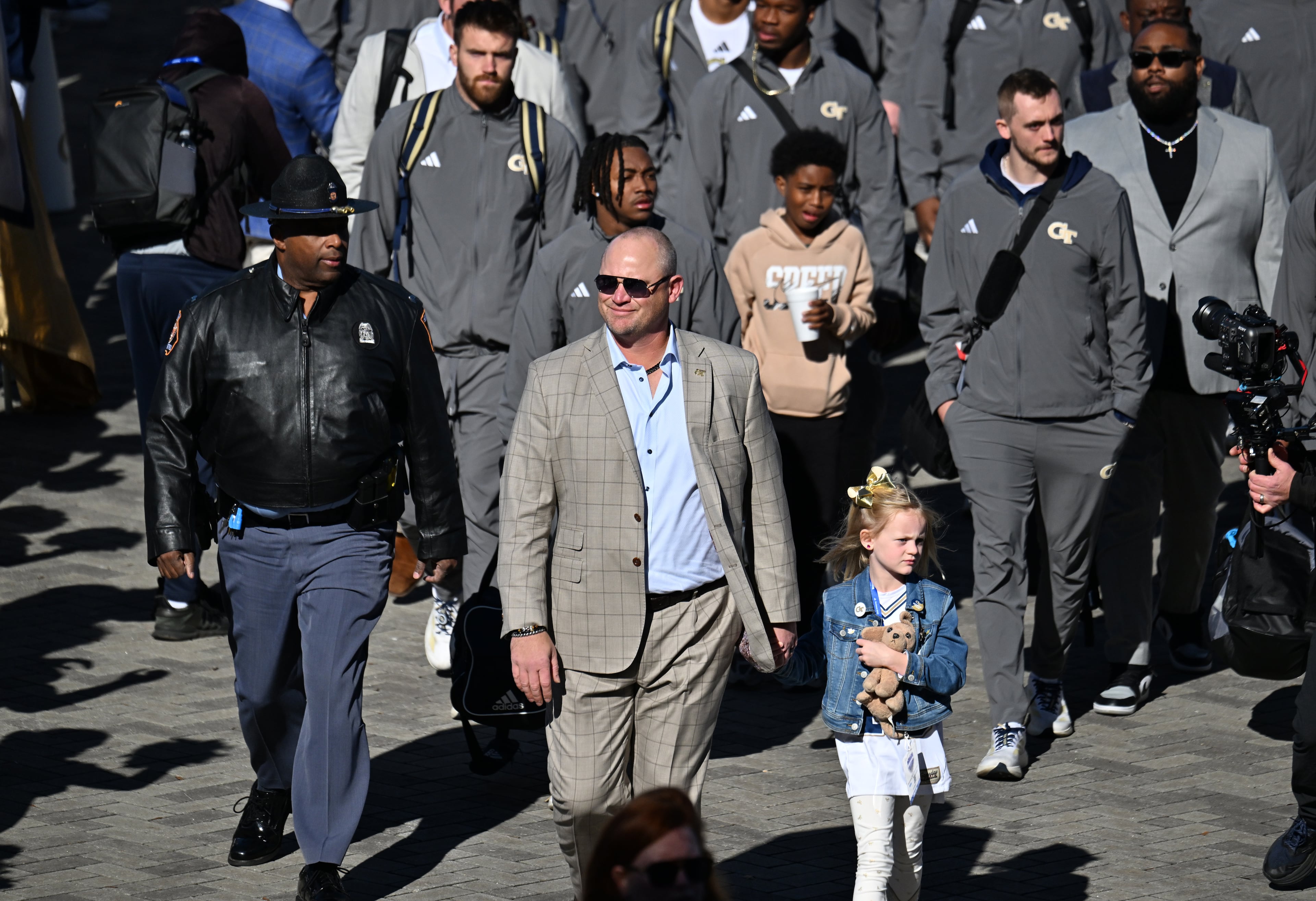 Georgia Tech head coach Brent Key with his daughter Harper arrives before the start of the Georgia Tech vs Georgia football game at Mercedes-Benz Stadium, Friday, Nov. 28, 2025 in Atlanta. (Hyosub Shin/AJC)