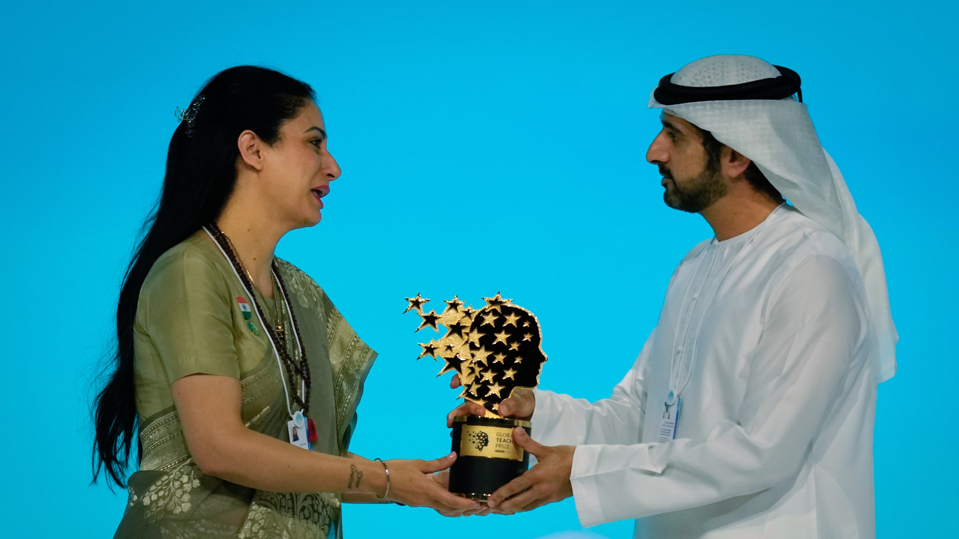 Indian teacher Rouble Nagi, left, receives the Global Teacher Prize trophy from Dubai Crown Prince Sheikh Hamdan bin Mohammed Al Maktoum, at a ceremony in Dubai, United Arab Emirates, Thursday, Feb. 5, 2026. (AP Photo/Altaf Qadri)