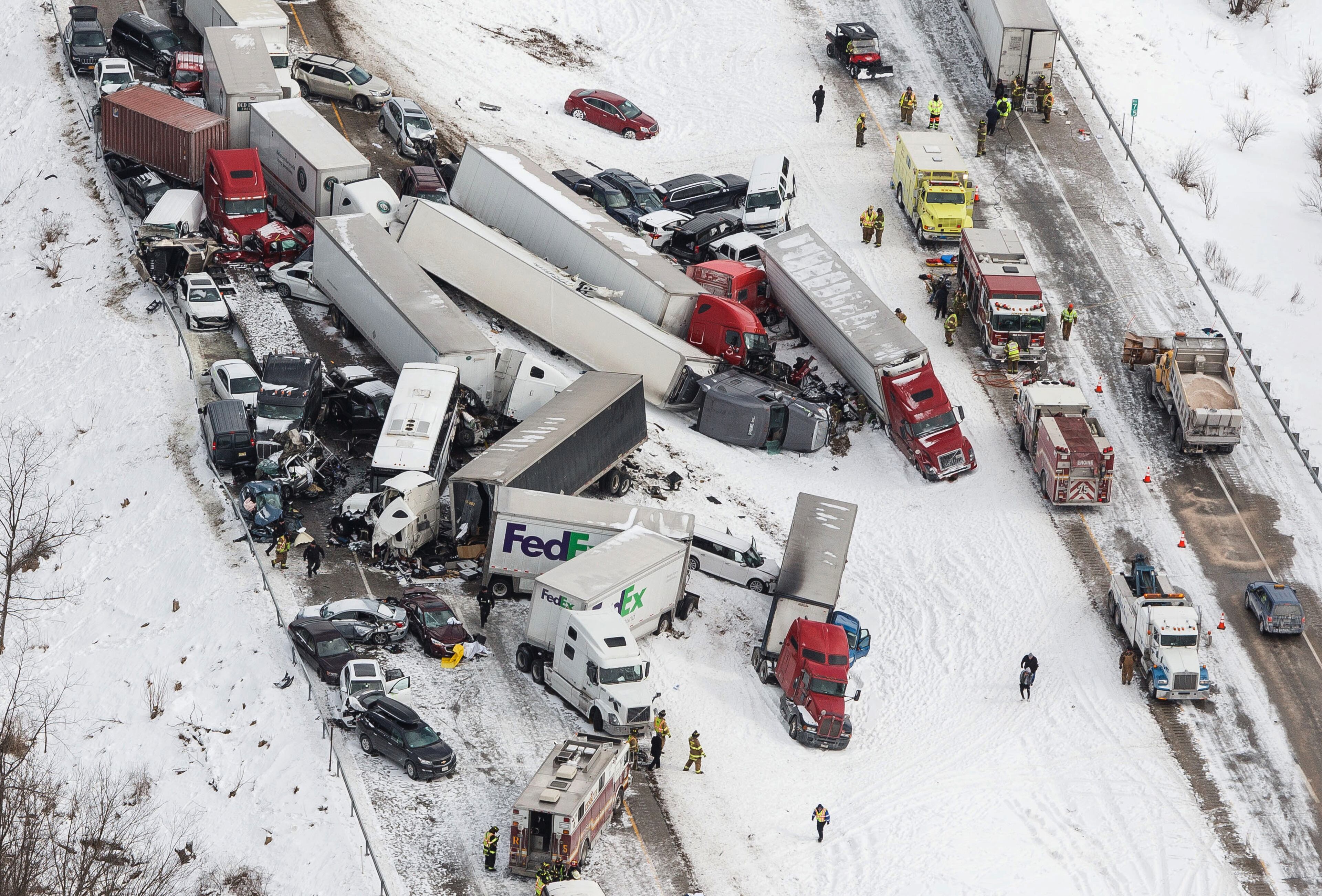 Vehicles pile up at the site of a fatal crash near Fredericksburg, Pa., Saturday, Feb. 13, 2016. The pileup left tractor-trailers, box trucks and cars tangled together across several lanes of traffic and into the snow-covered median. (James Robinson/PennLive.com via AP)