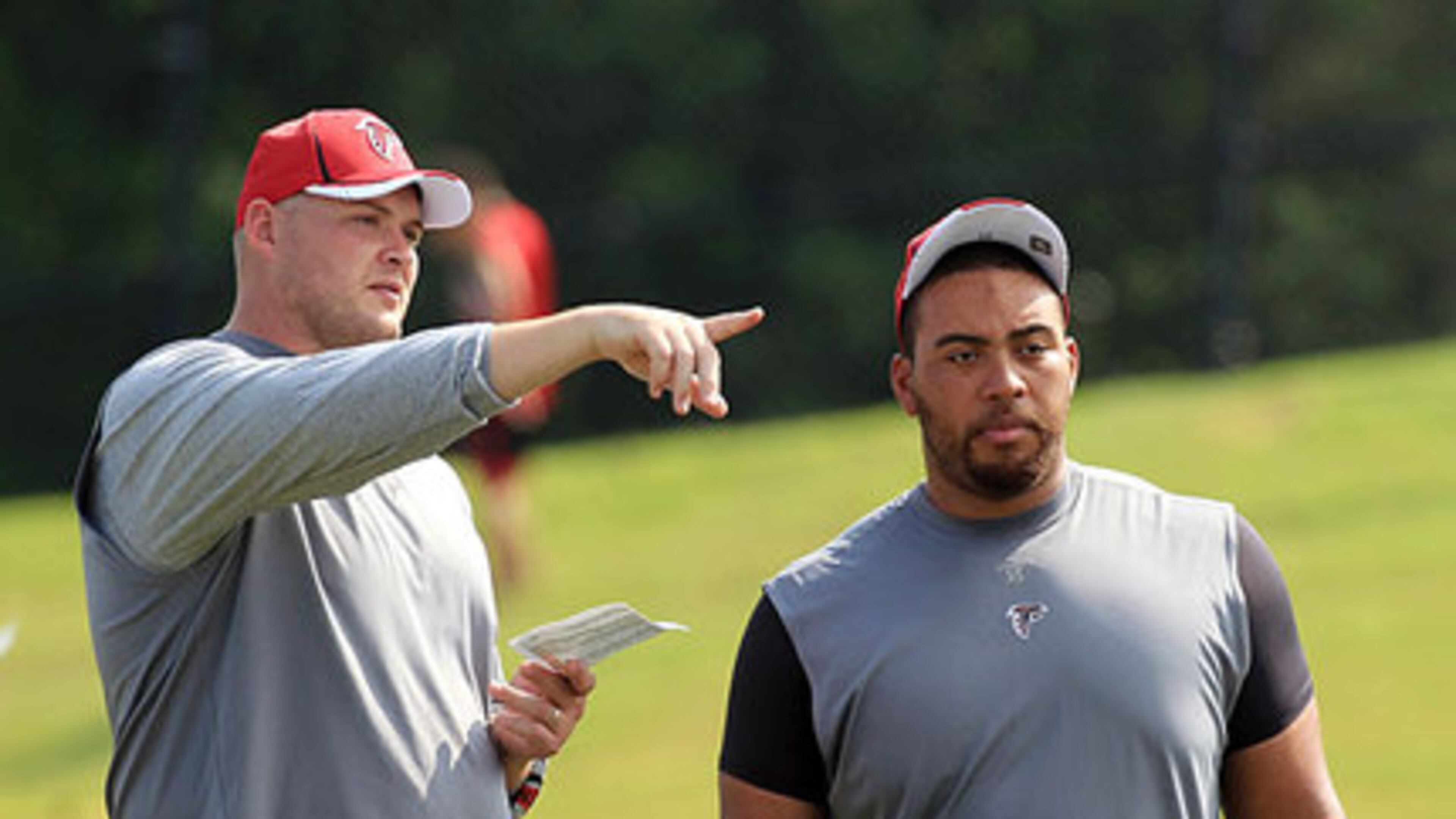 FILE PHOTO -- 110801 Flowery Branch - Offensive tackle Tyson Clabo, left, and offensive guard Justin Blalock, right, who just signed a contract with the Falcons, watch practice but are not yet able to participate while players run through the first padded practice at training camp in Flowery Branch on Monday, August 1, 2011. Curtis Compton ccompton@ajc.com FILE PHOTO -- 110801 Flowery Branch - Offensive tackle Tyson Clabo, left, and offensive guard Justin Blalock, right, who just signed a contract with the Falcons, watch practice but are not yet able to participate while players run through the first padded practice at training camp in Flowery Branch on Monday, August 1, 2011. Curtis Compton ccompton@ajc.com