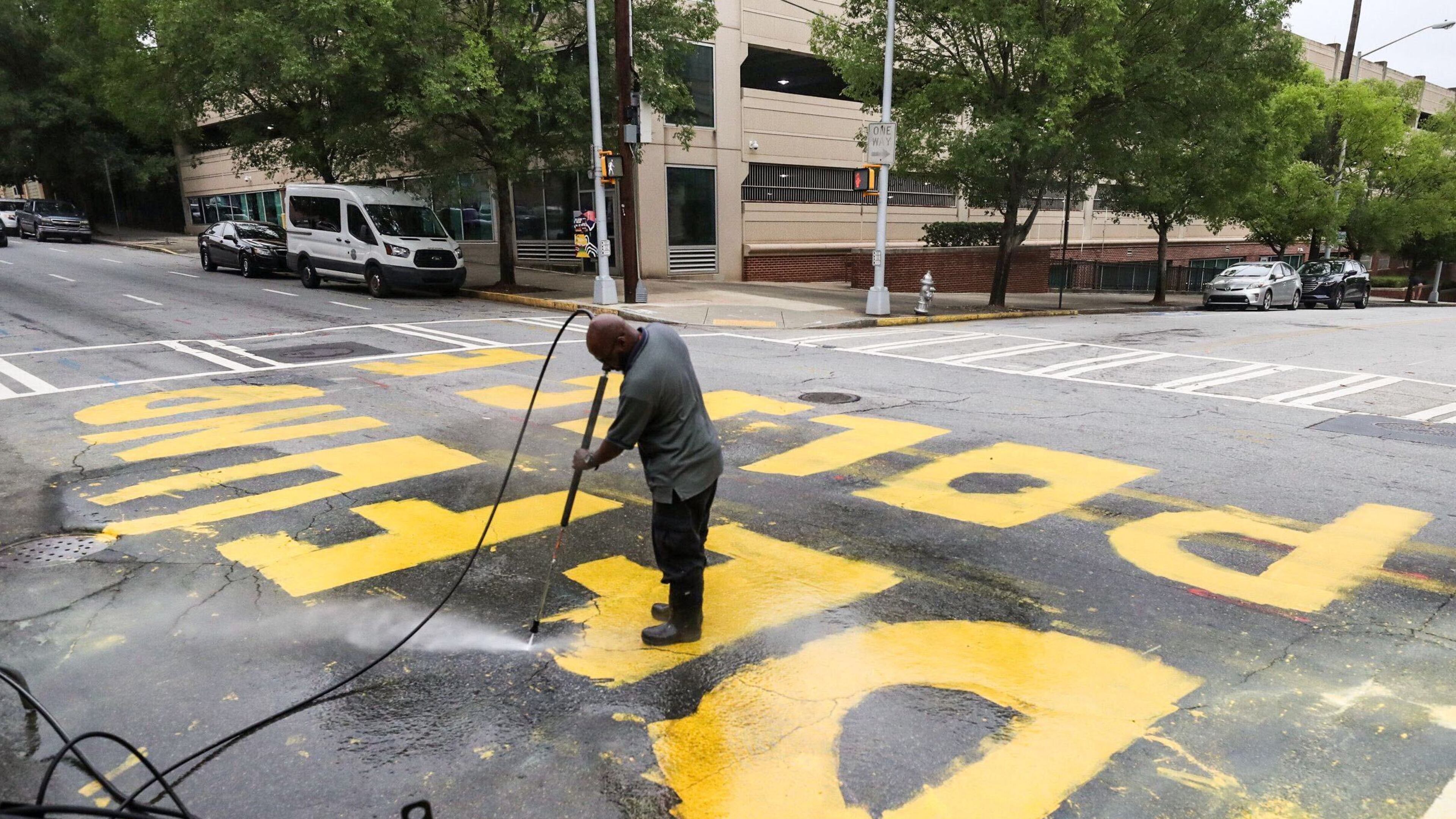 The message was painted in yellow letters outside of Atlanta Police Department headquarters. A city employee pressure-washed the paint off the road Wednesday morning.