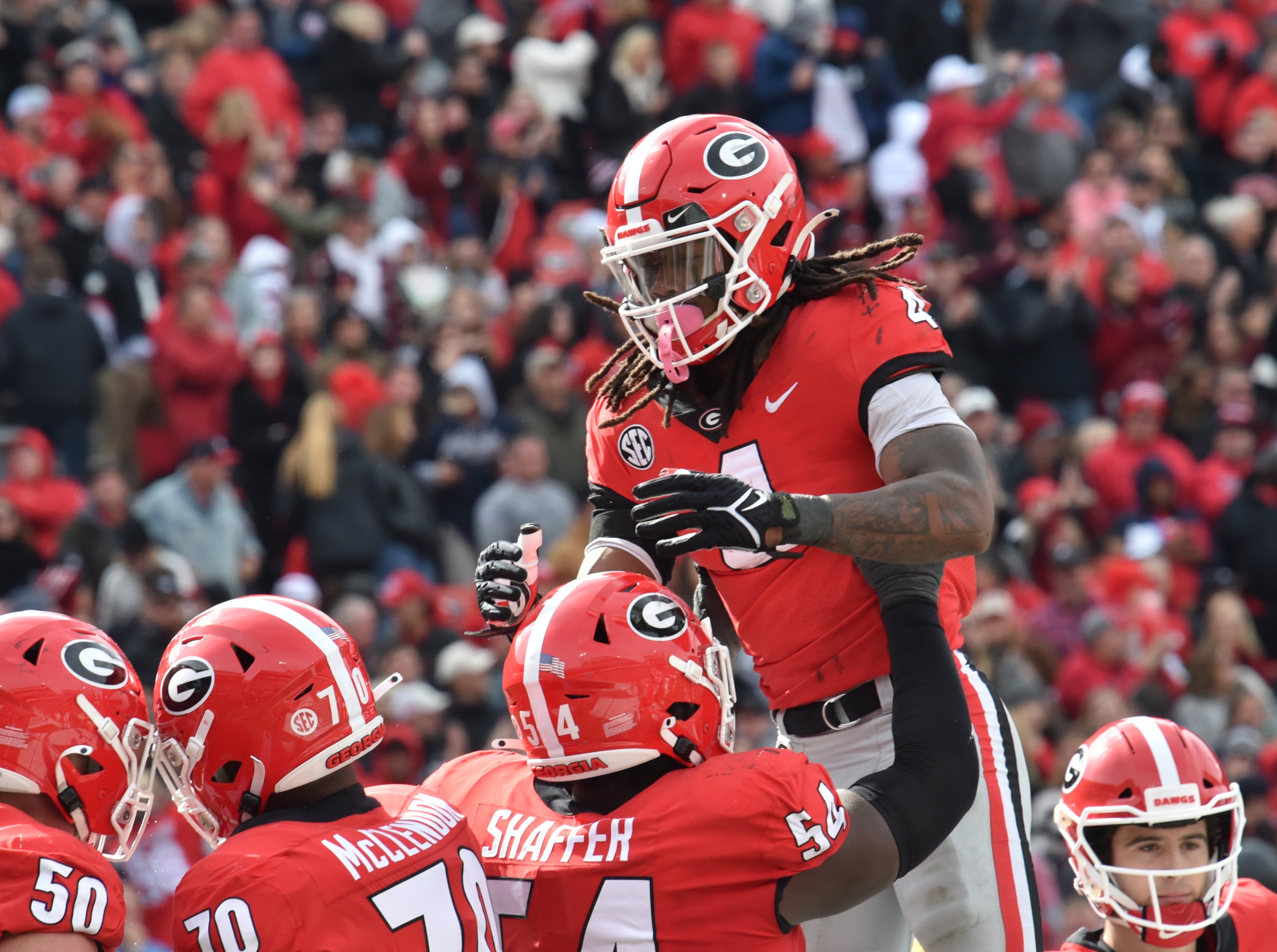 Georgia's running back James Cook (4) celebrates with teammates after he scored a touchdown in the second half during a NCAA football game at Sanford Stadium in Athens on Saturday, November 6, 2021. Georgia won 43-6 over Missouri. (Hyosub Shin / Hyosub.Shin@ajc.com)
