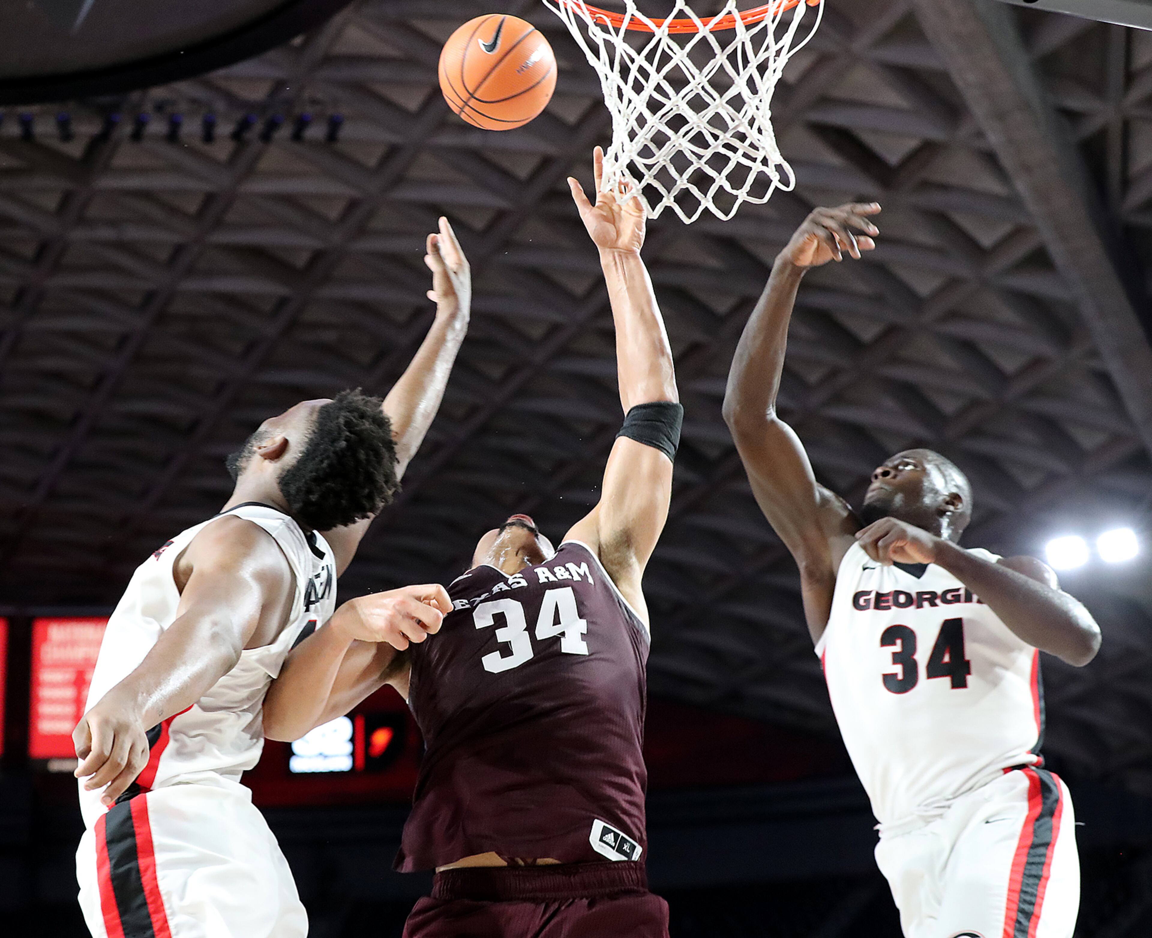 Feb 28, 2018 Athens: Texas A&M center Tyler Davis knocks the ball away from Georgia forward Yante Maten and Derek Ogbeide in the final seconds to hold on to a 61-60 victory over Georgia in their NCAA college basketball game on Wednesday, Feb 28, 2018, in Athens. Curtis Compton/ccompton@ajc.com