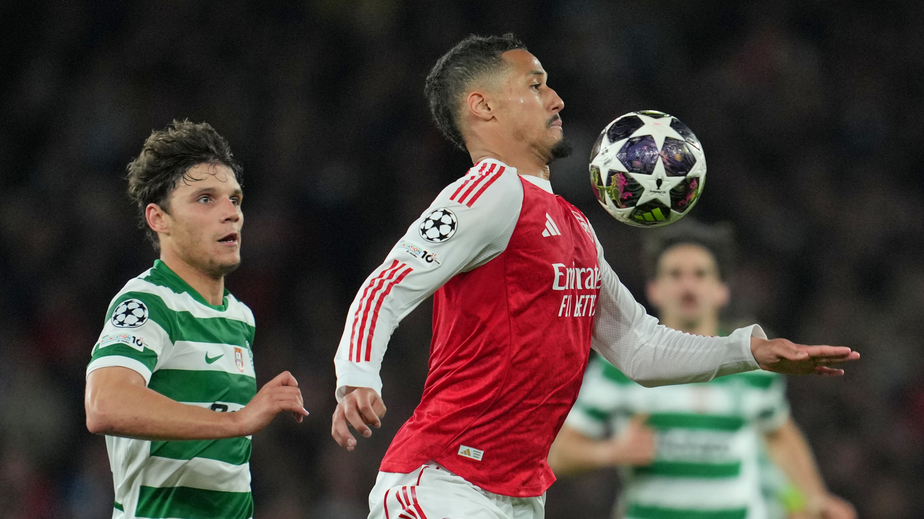 Arsenal's William Saliba, front, and Sporting's Eduardo Quaresma pfp during the UEFA Champions League second leg quarterfinal soccer match between Arsenal and Sporting in London, England, Wednesday, April 15, 2026. (AP Photo/Kin Cheung)