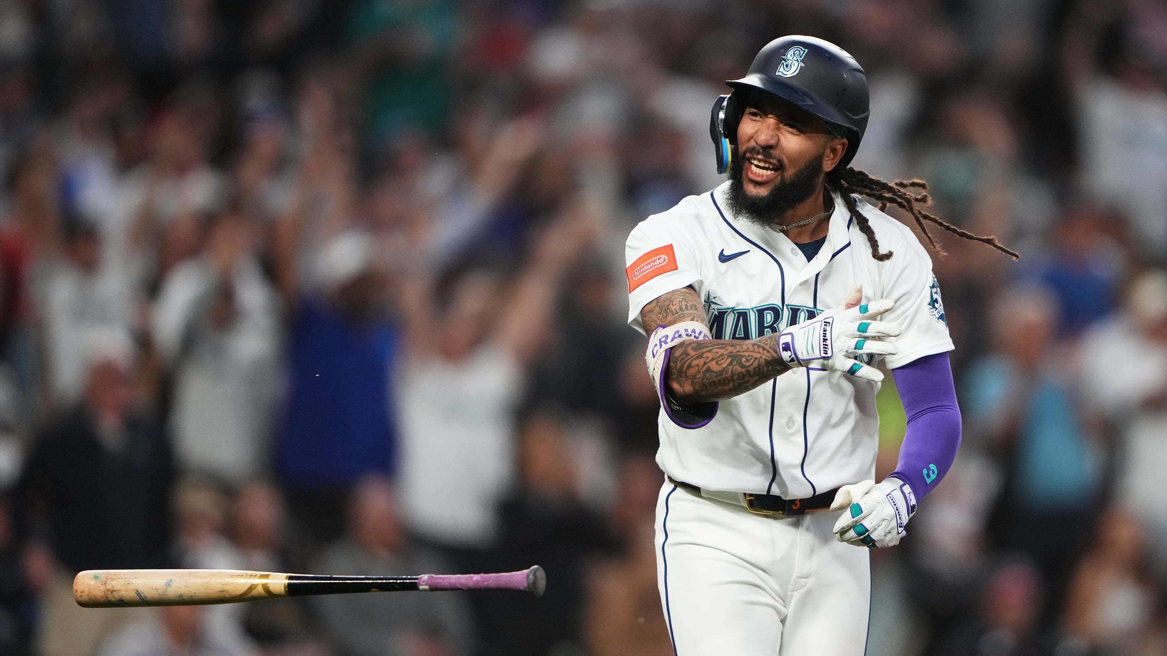 Seattle Mariners' J.P. Crawford celebrates after hitting a two-run home run against the Atlanta Braves during the sixth inning of a baseball game, Monday, May 4, 2026, in Seattle. (AP Photo/Lindsey Wasson)