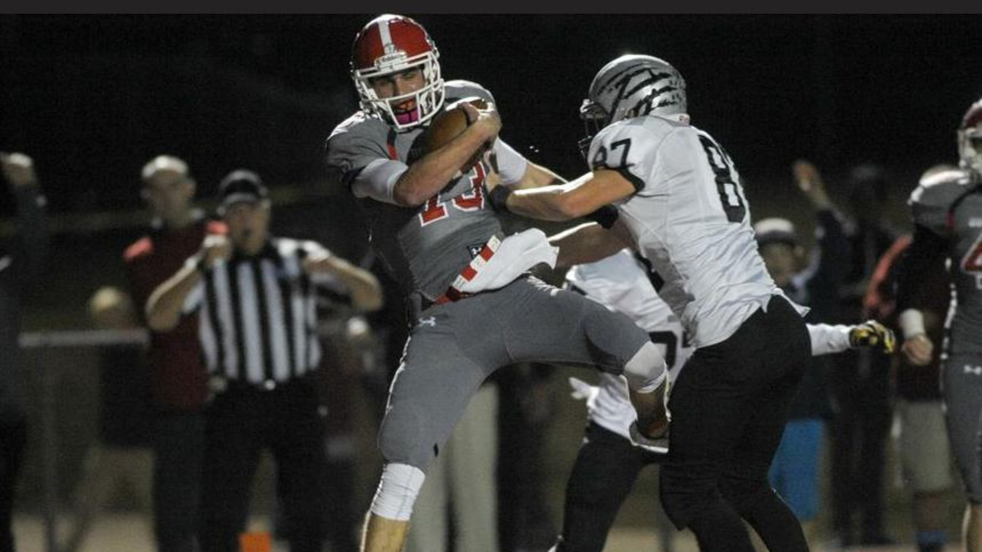 Acworth, Ga. -- Altoona senior quarterback Brandon Rainey (13) stumbles into the end zone for a touch down in the first half of play as Houston County senior defensive end Salomon Raas (87) defends in the third round of football playoffs Friday, November 27, 2015. SPECIAL/DANIEL VARNADO