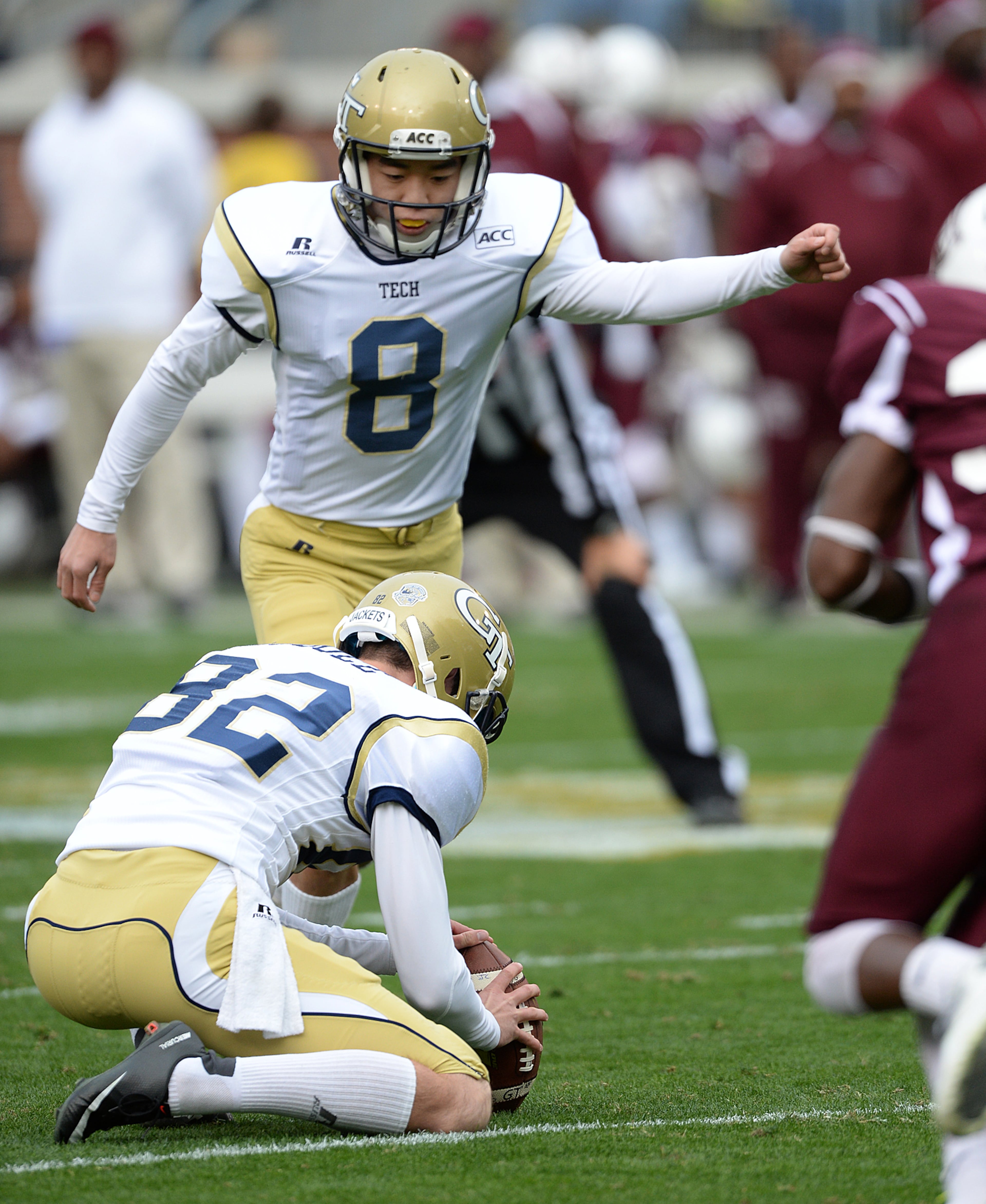 Georgia Tech's kicker Andrew Chau (8) watches as Sean Poole (82) holds the ball for the extra point during Georgia Tech's 66 to 7 victory over Alabama A&M in Bobby Dodd Stadium. Georgia Tech won the game 66 to 7.