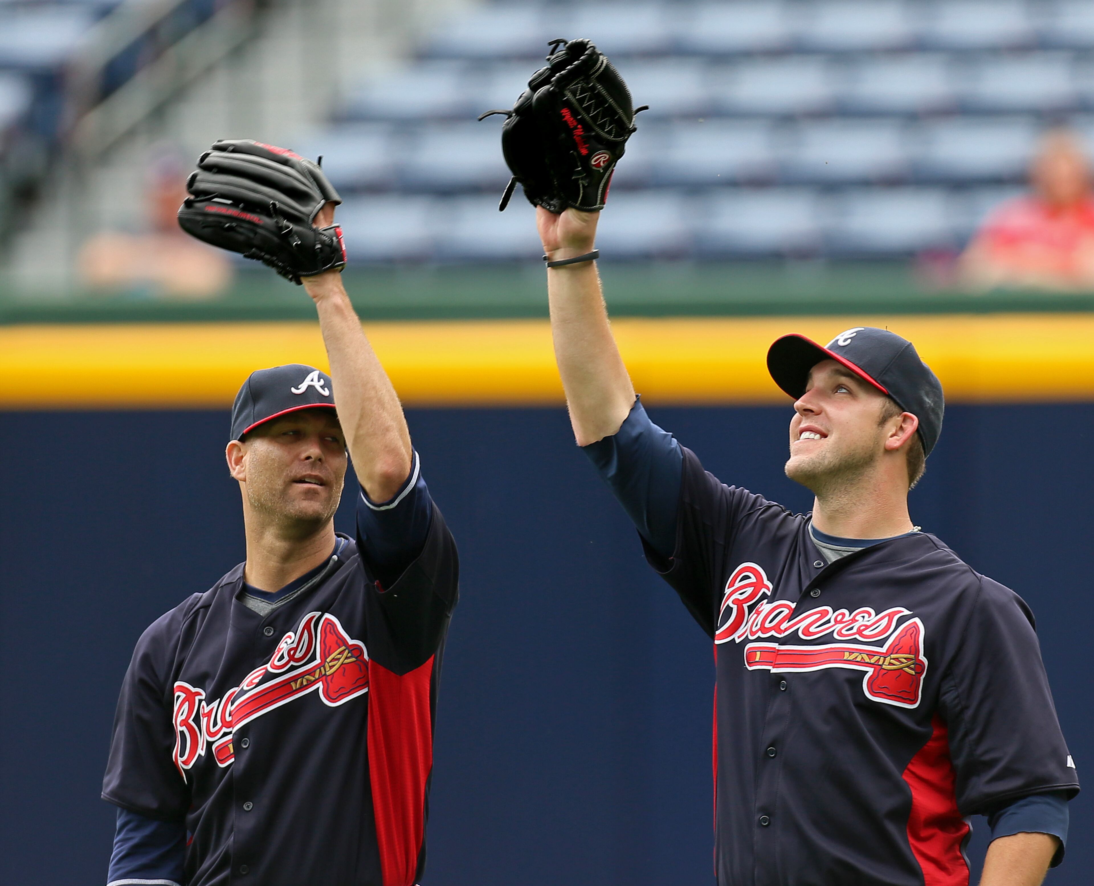I got it! No I got it! Braves pitchers Tim Hudson (left) and Paul Malholm both act like they are going to catch a fly ball in the outfield during team batting practice before playing the Nationals.