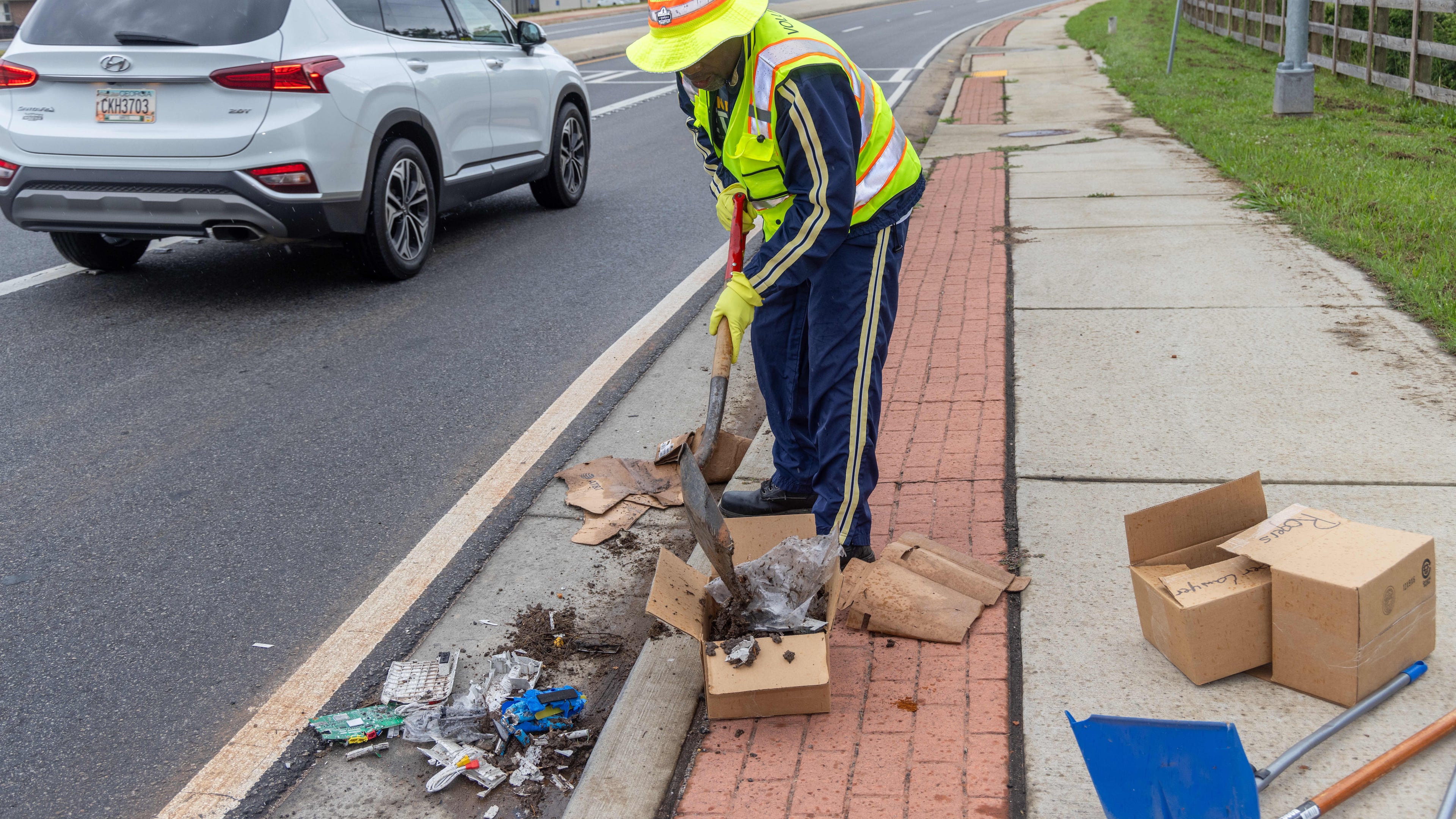 Anthony "Spark Plug" Thomas cleans up litter & debris at the Highway 92 traffic circle at Antioch & Lockwood roads in Fayetteville in 2024. (Phil Skinner for the AJC)
