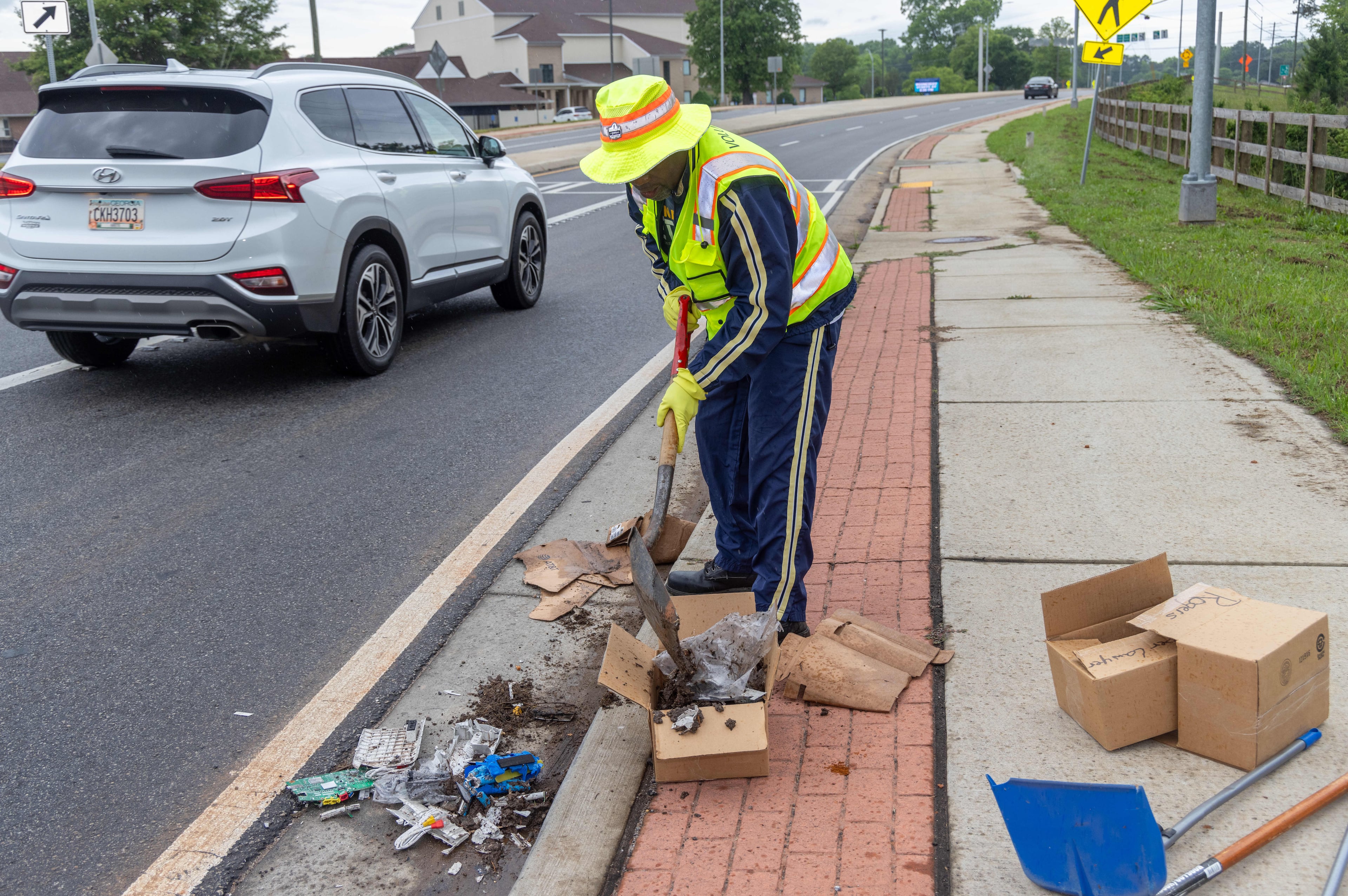 Anthony "Spark Plug" Thomas cleans up litter & debris at the Highway 92 traffic circle at Antioch & Lockwood roads in Fayetteville in 2024. (Phil Skinner for the AJC)