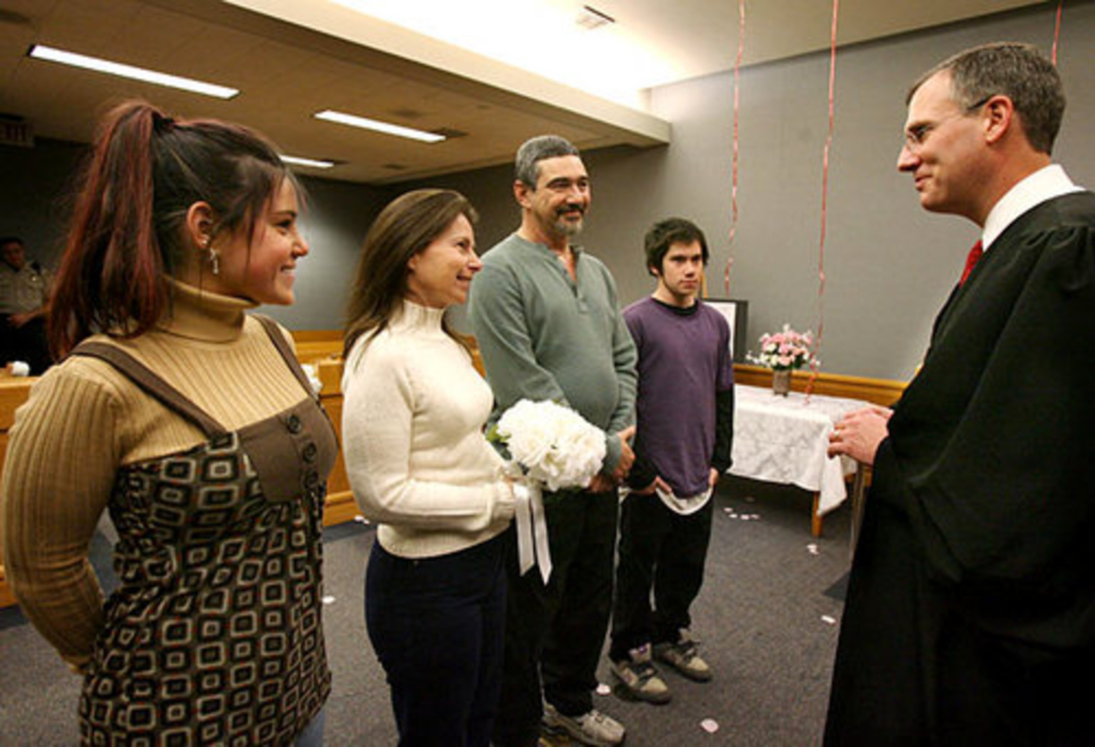 Daughter Brandy Gottlieb (far left), 20, and son Chase (far right), 16, watch as Gwinnett County Chief Magistrate George Hutchinson, III, officiates at the renewal of their parents' marriage vows.