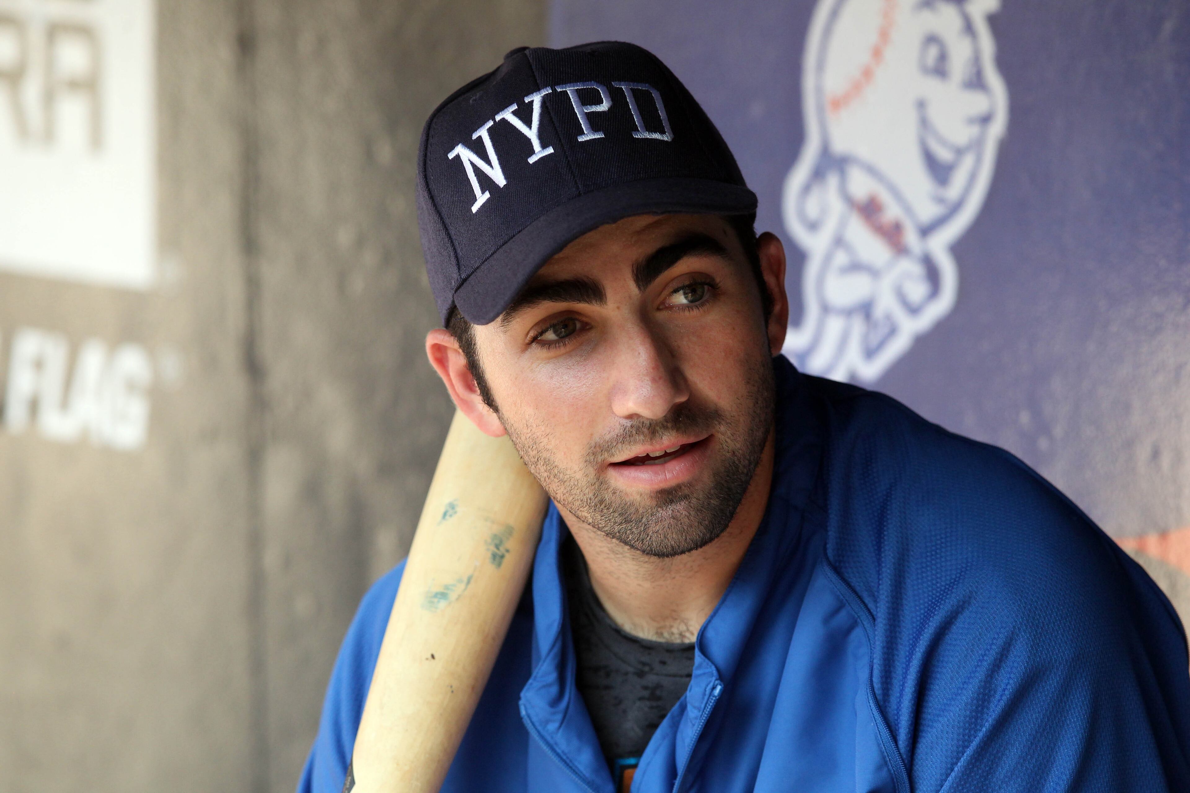 New York Mets first baseman Josh Satin (13) wears an NYPD cap in remembrance of 9/11/01 during batting practice before a game against the Washington Nationals at Citi Field.