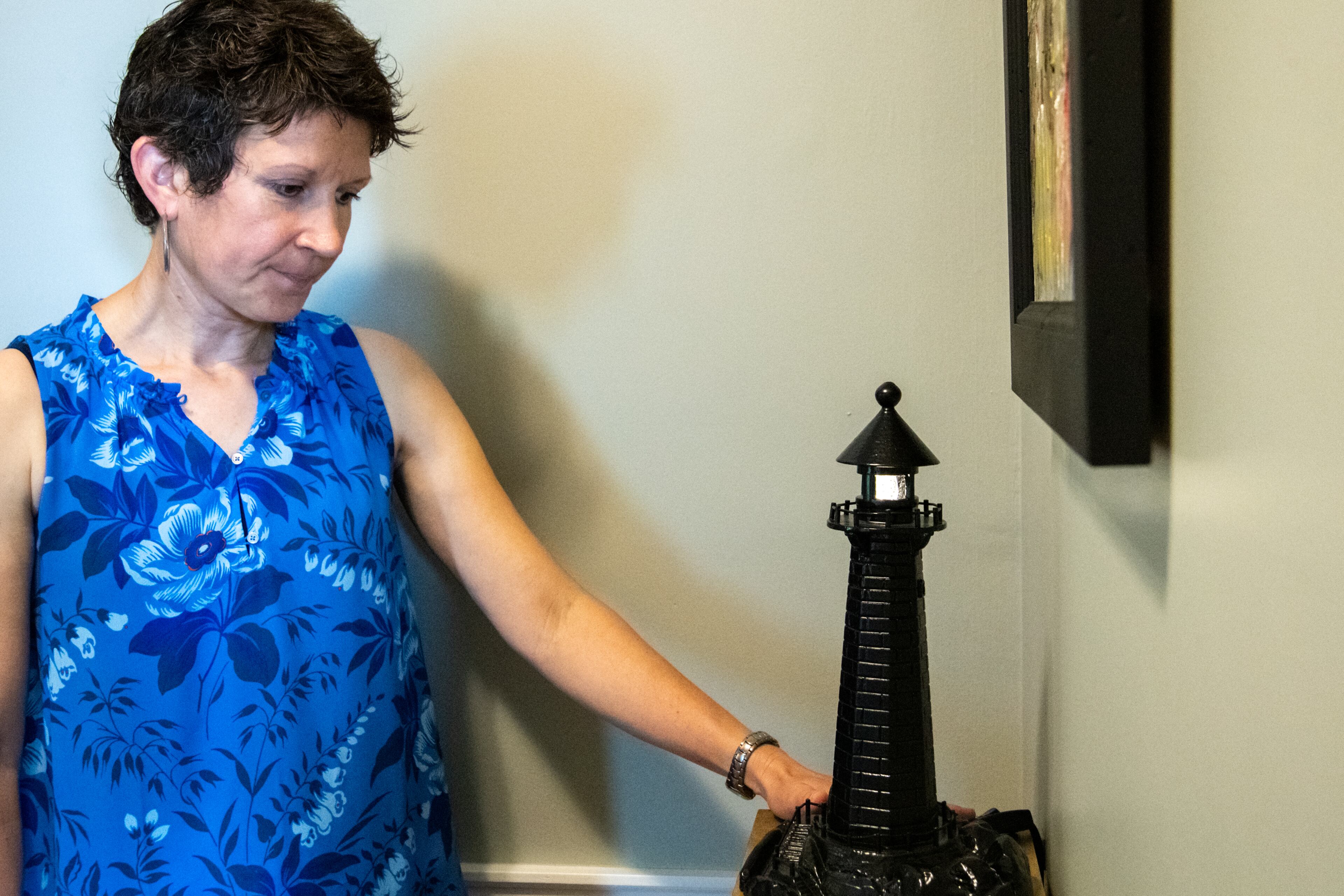 Stephanie Blanchard, granddaughter of Eugene Blanchard, displays a lighthouse, which she always keeps on. It belonged to her grandfather, Eugene Blanchard, who lost his life at Pearl Harbor on the USS Oklahoma. MIKE CAUDILL FOR THE ATLANTA JOURNAL-CONSTITUTION