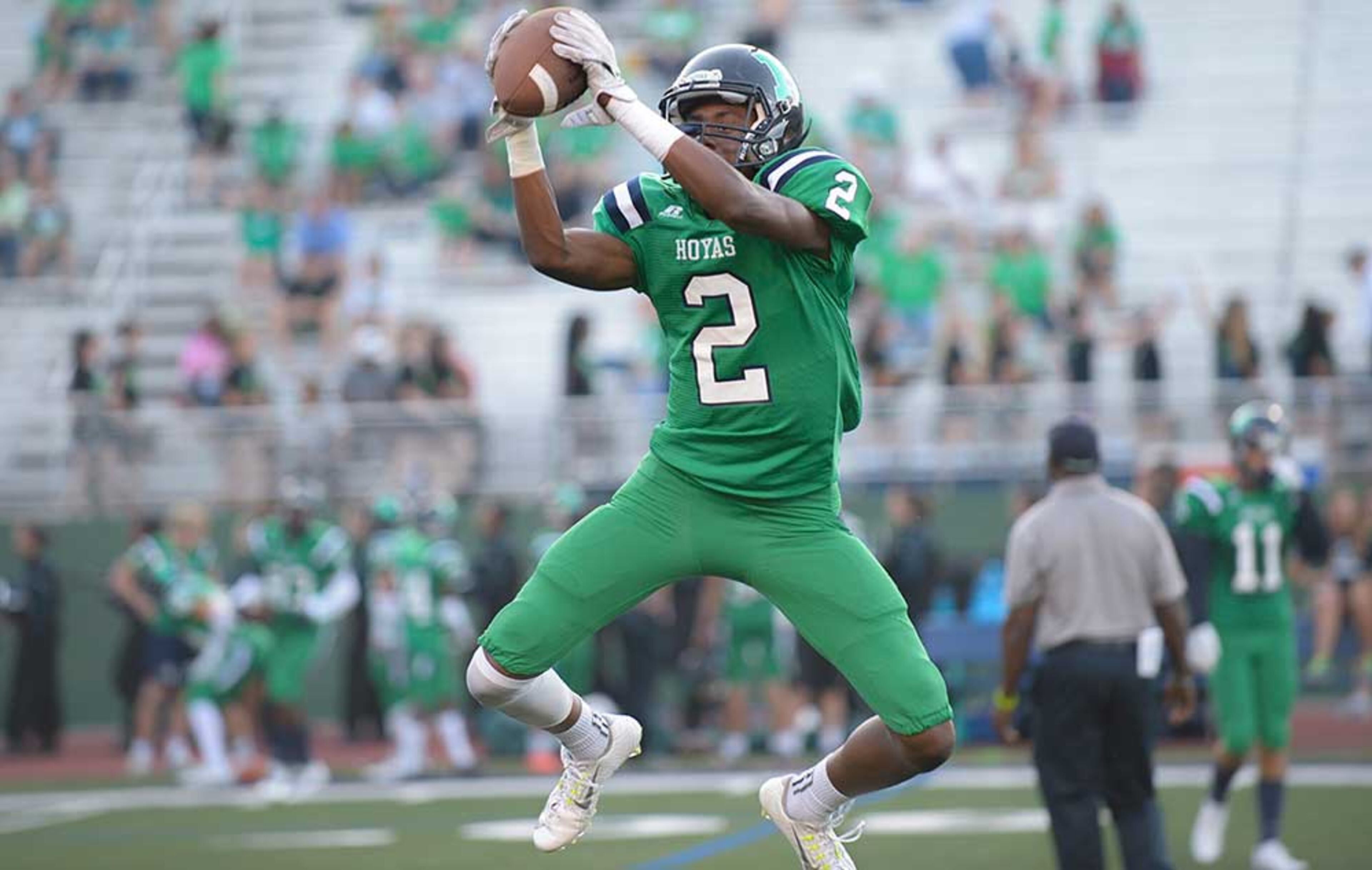 Harrison sophomore WR Mrio Nunez (2) jumps to make a catch during warm up drills prior to his game against Allatoona Friday.
