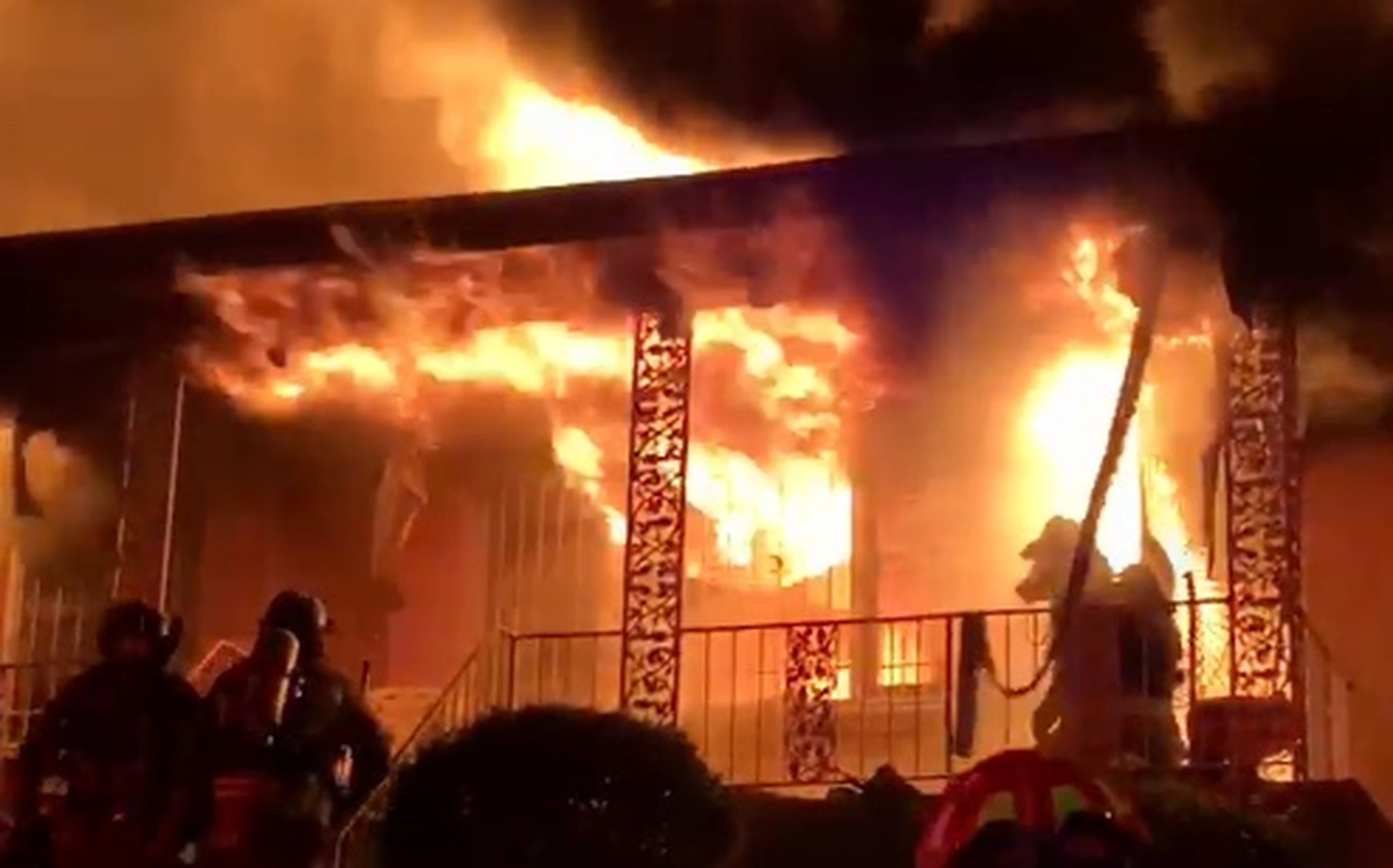 Atlanta fire Capt. Danny Dwyer kneels on the porch after pulling 94-year-old Sallie Skrine from her home.