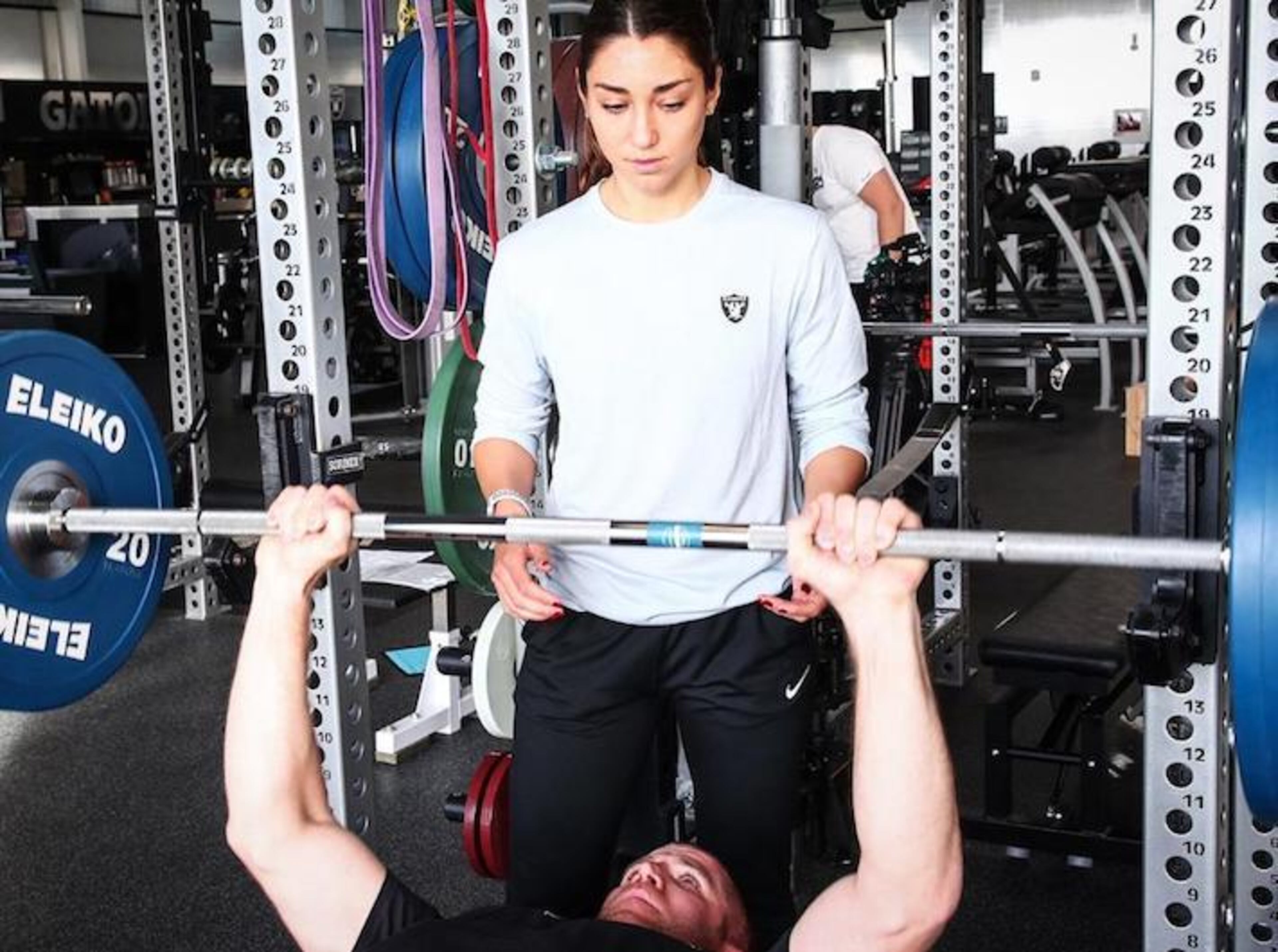 Kelsey Martinez, the first female coach in Raiders history, helps wide receiver Jordy Nelson on the bench press on April 9, 2018. (Oakland Raiders/TNS)