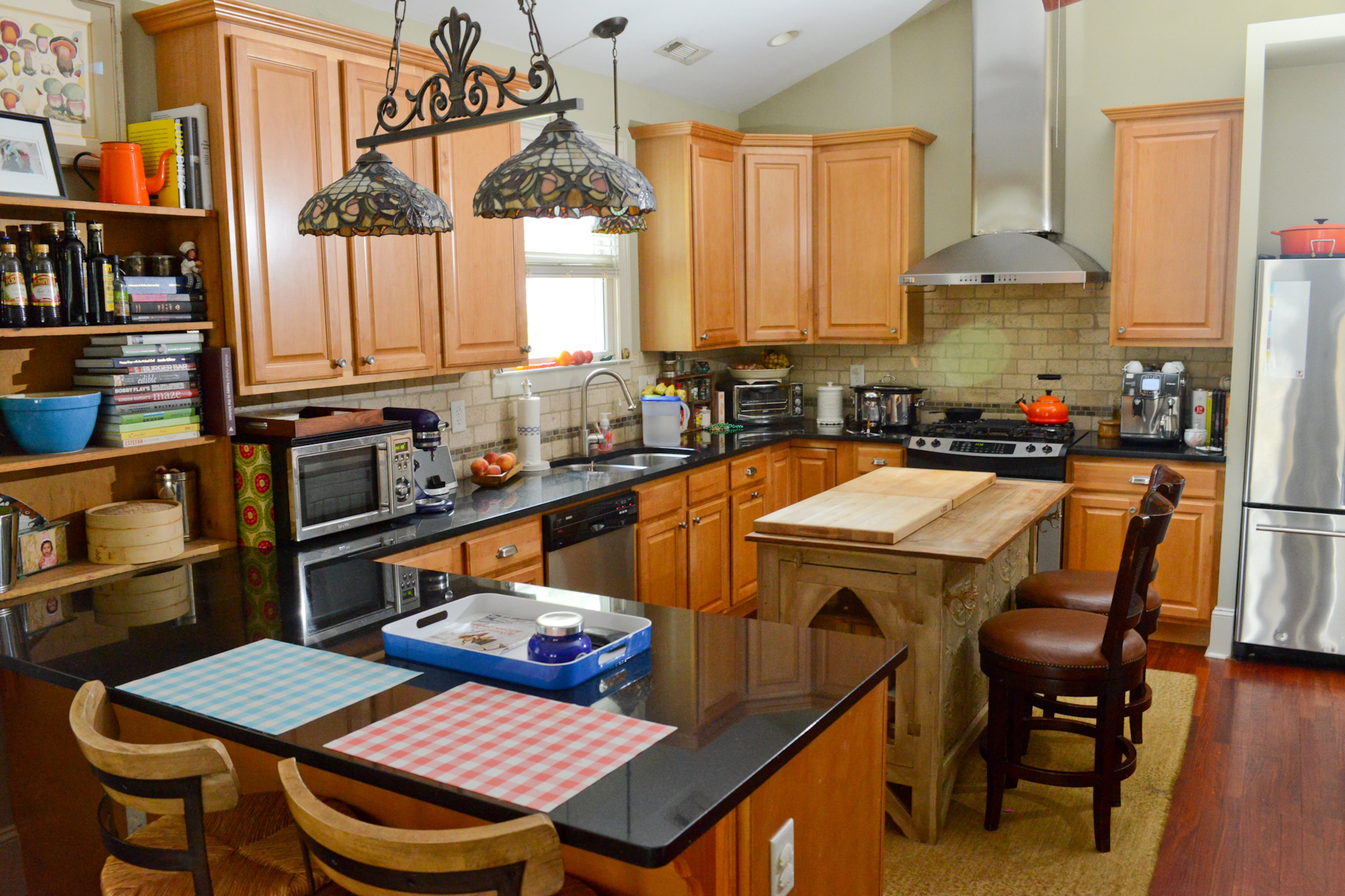 Tiffany-style light fixtures hang over black granite countertops in the cozy kitchen of the Decatur home. The kitchen, with Bosch, Jenn-Air and Frigidaire appliances, is a much-used room for chef Robert Phalen (of One Eared Stag), wife Allison and their three kids.--Text by Lori Johnston