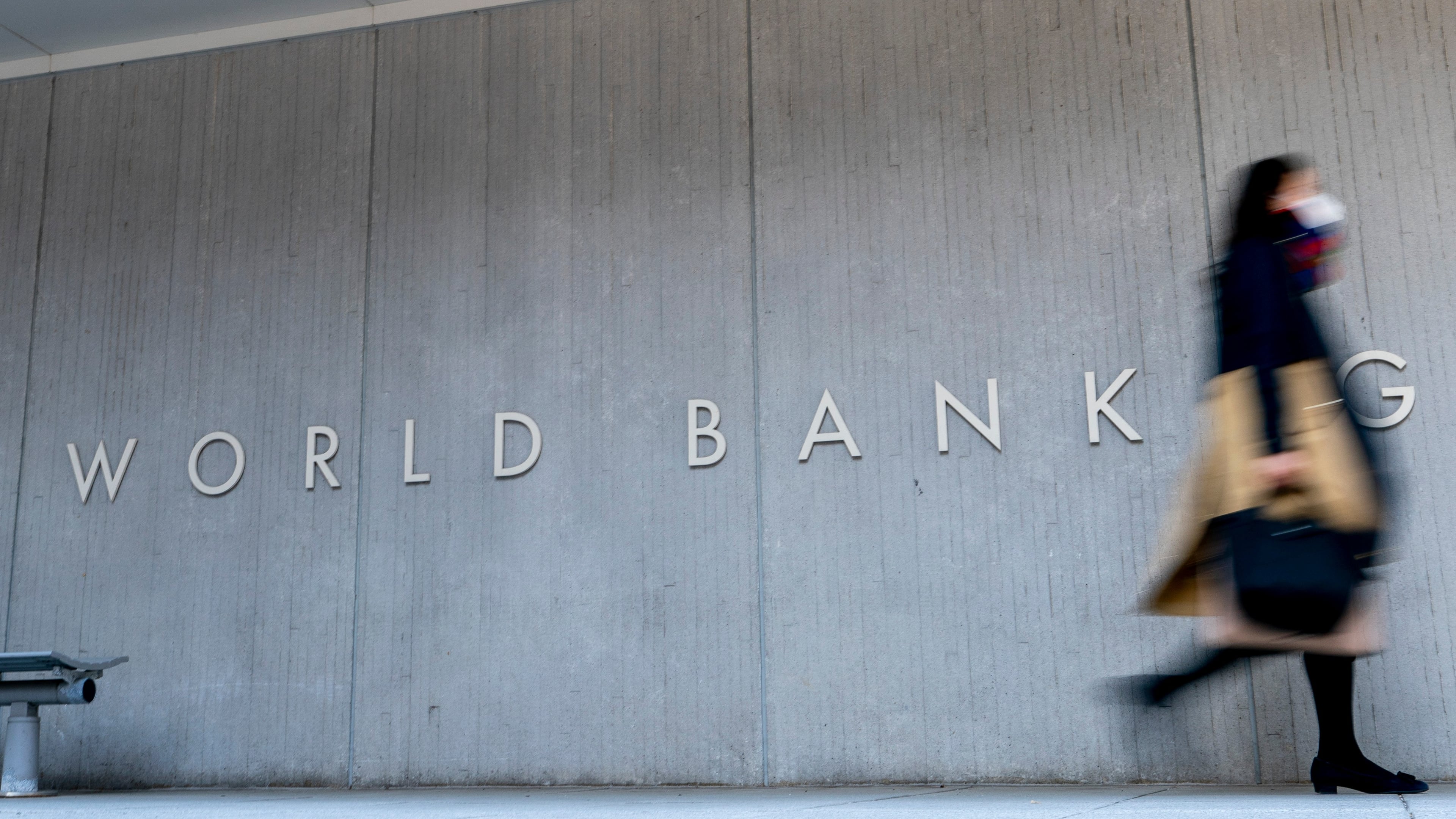 FILE - A woman walks past the World Bank building in Washington on April 5, 2021. (AP Photo/Andrew Harnik, File)PRNTO