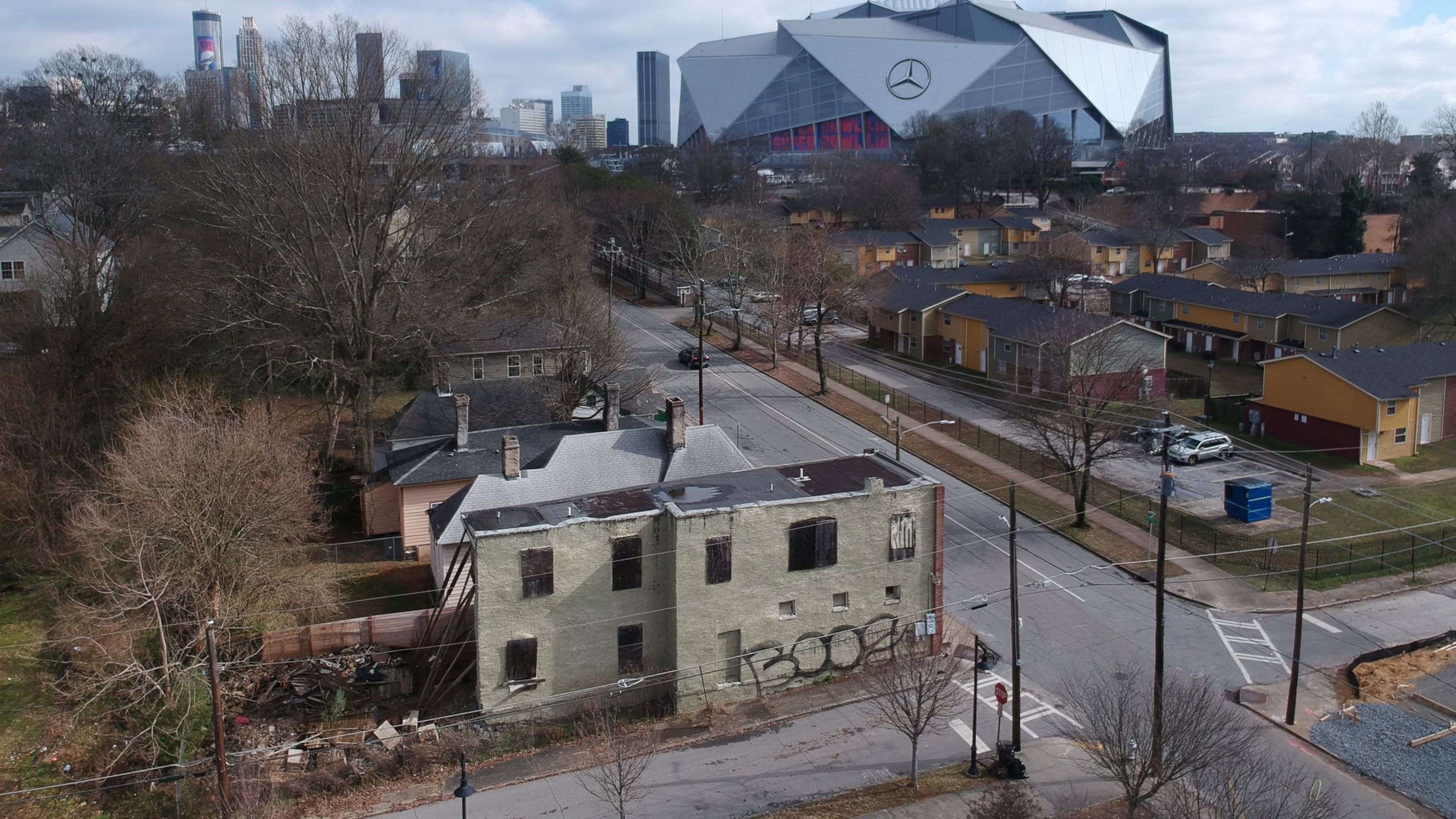 Aerial view of neighborhoods west of downtown Atlanta in the foreground and Mercedes-Benz Stadium in the background on Thursday, January 24, 2019. HYOSUB SHIN / HSHIN@AJC.COM