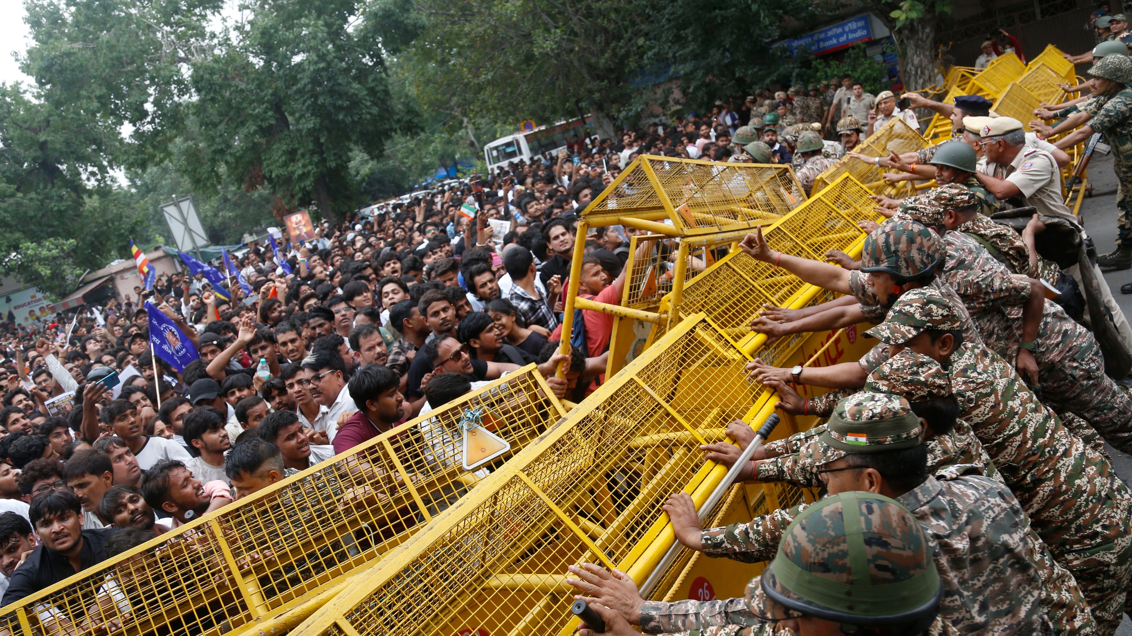Supporters of the Cockroach Janta Party push against a barricade as they attempt to march to India's Parliament, demanding the resignation of the education minister, in New Delhi, Monday, July 20, 2026. (AP Photo/Shekhar Yadav)