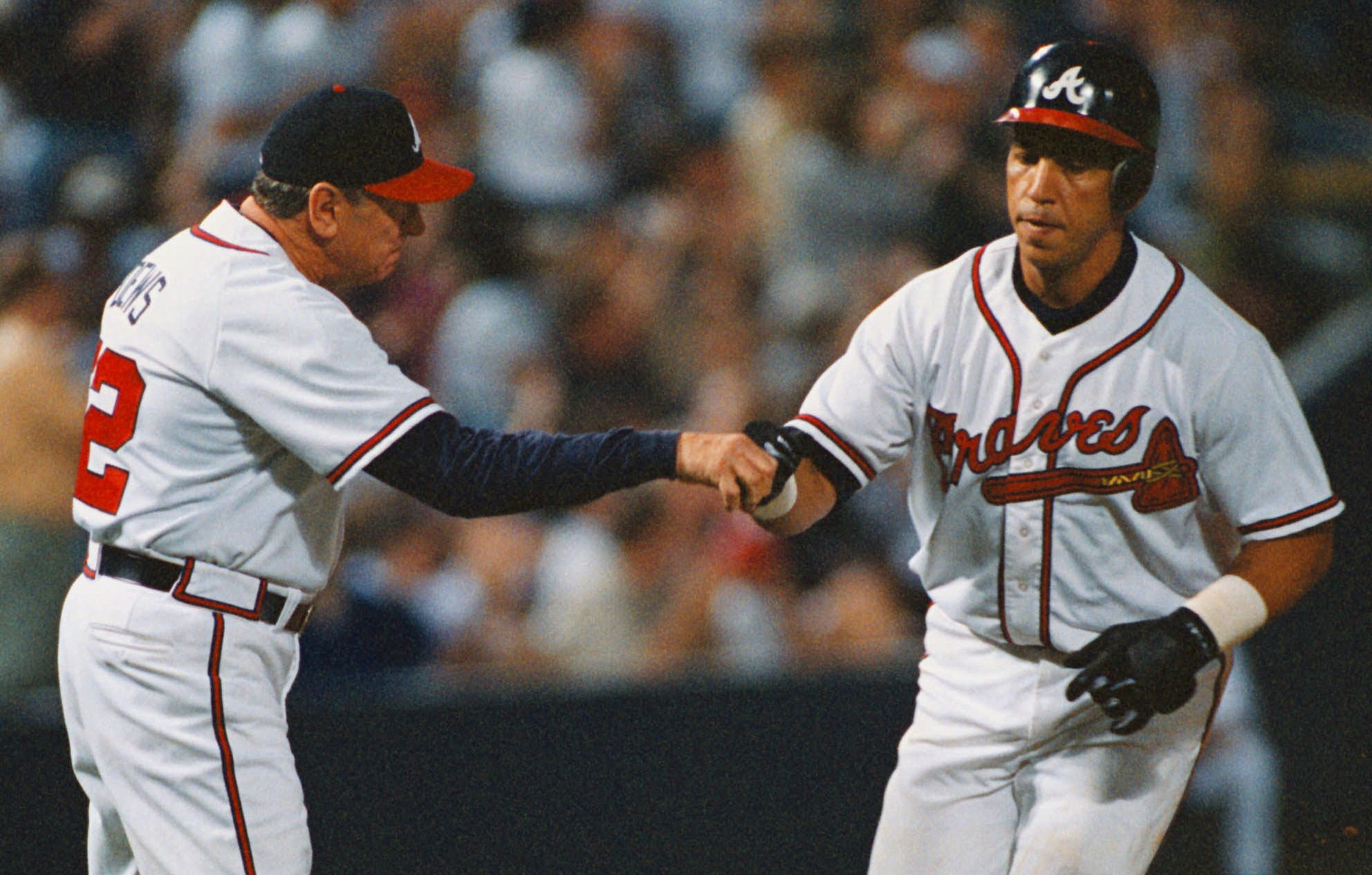 Atlanta Braves' Andres Galarraga, right, is congratulated by third base coach Bobby Dews after hitting his 11th home run off San Diego Padres starting pitcher Joey Hamilton in the bottom of the fourth inning on Thursday. May 7, 1998 at Turner Field in Atlanta. The Braves have at least one homer in 19 consecutive games, one shy of the club record and five short of the NL mark. The Braves defeated the Padres 6-3. (AP Photo/Erik S. Lesser)