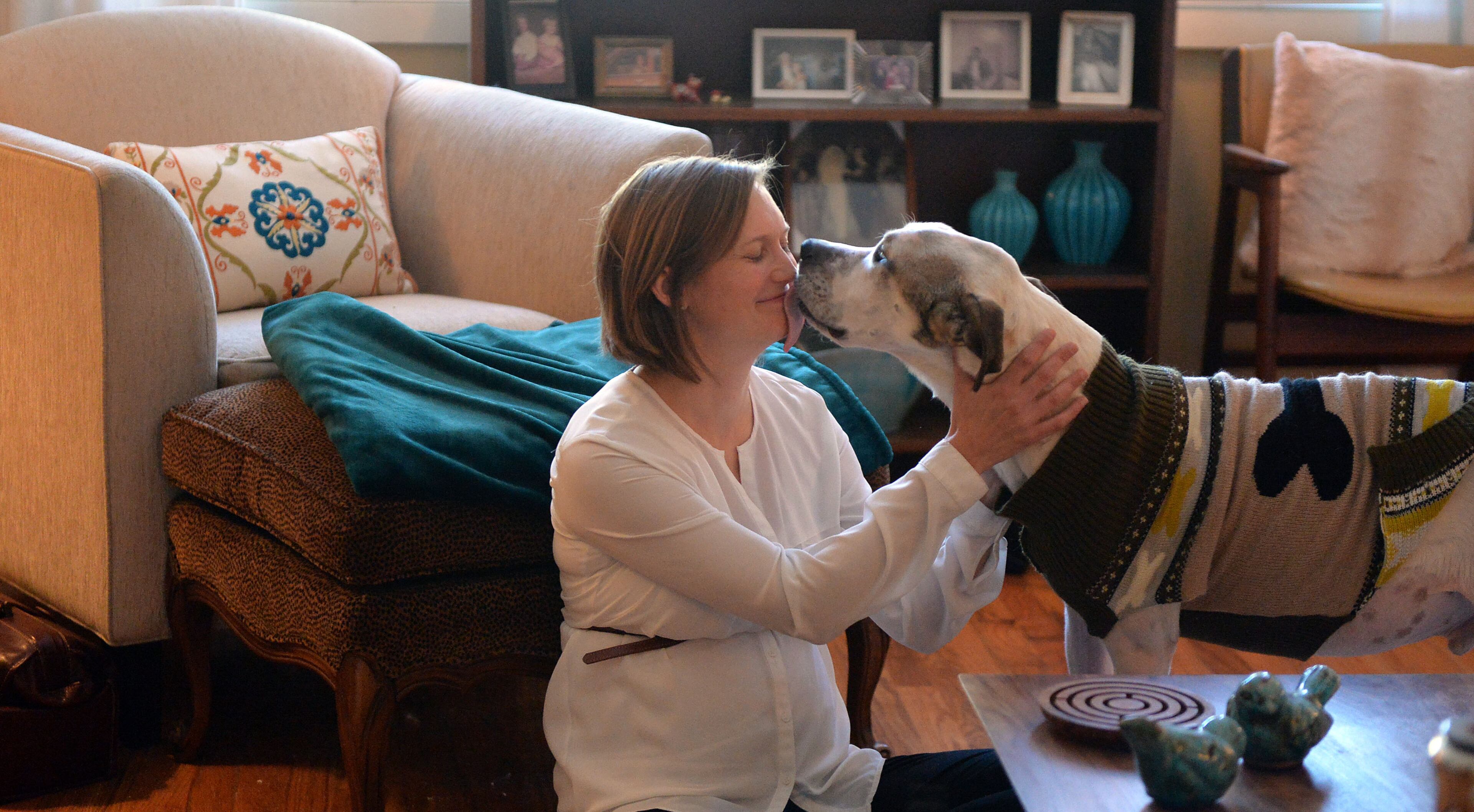 NOVEMBER 18, 2014 DECATUR Veterinarian Lauren Cassady visits with Catherine and Hunter Harris and their pet, Winston, at their Decatur home, Tuesday, November 18, 2014. Cassady has one of the toughest jobs in the pet world. She runs a hospice program for pets. KENT D. JOHNSON/KDJOHNSON@AJC.COM