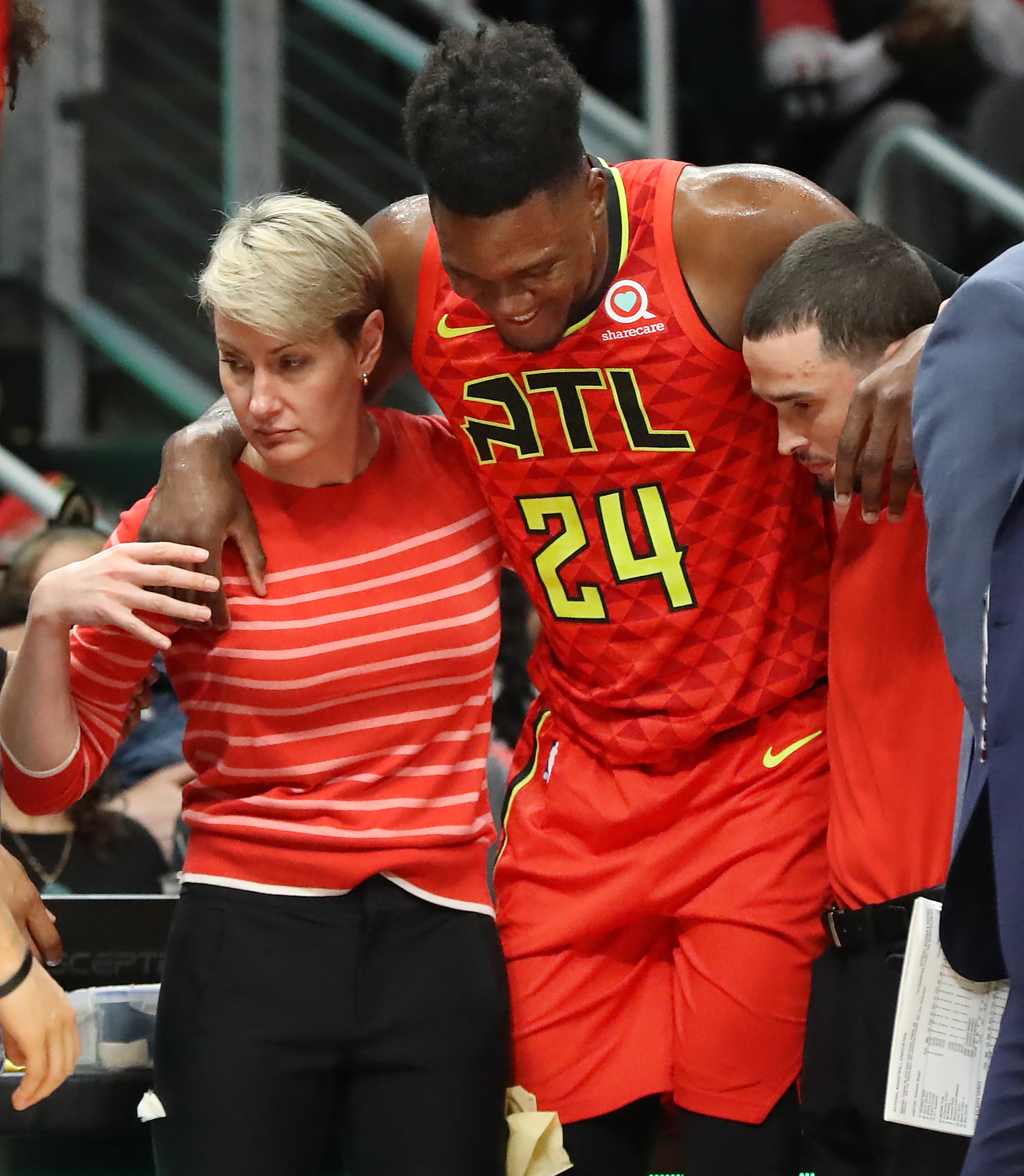 Hawks forward Bruno Fernando is helped off the court with an apparent injury during the second half against the Orlando Magic in the home opener in a NBA basketball game on Saturday, October 26, 2019, in Atlanta. Curtis Compton/ccompton@ajc.com