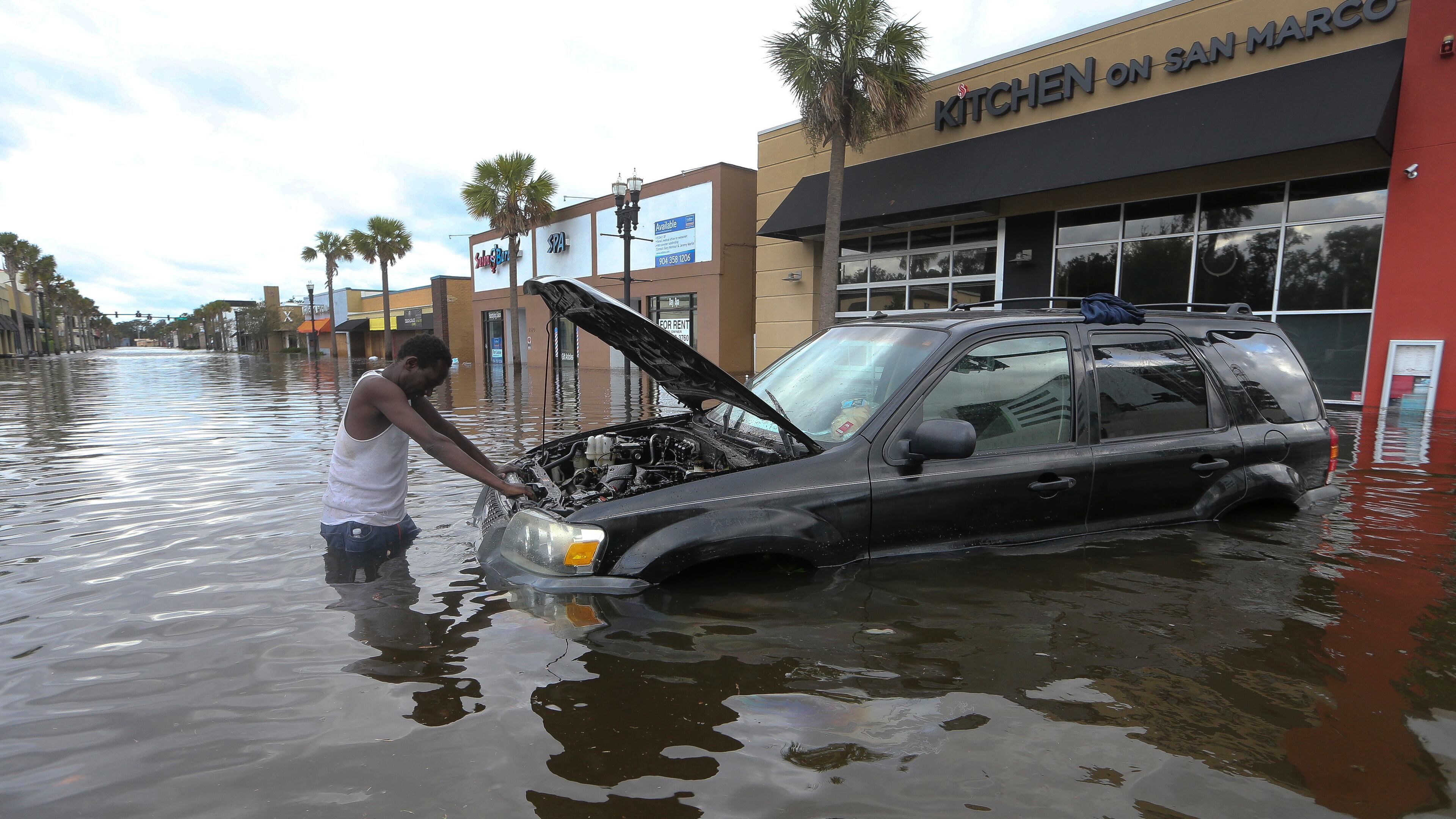 John Duke tries to figure out how to salvage his flooded vehicle in the wake Hurricane Irma, Monday, Sept. 11, 2017, in Jacksonville, Fla. (AP Photo/John Bazemore)